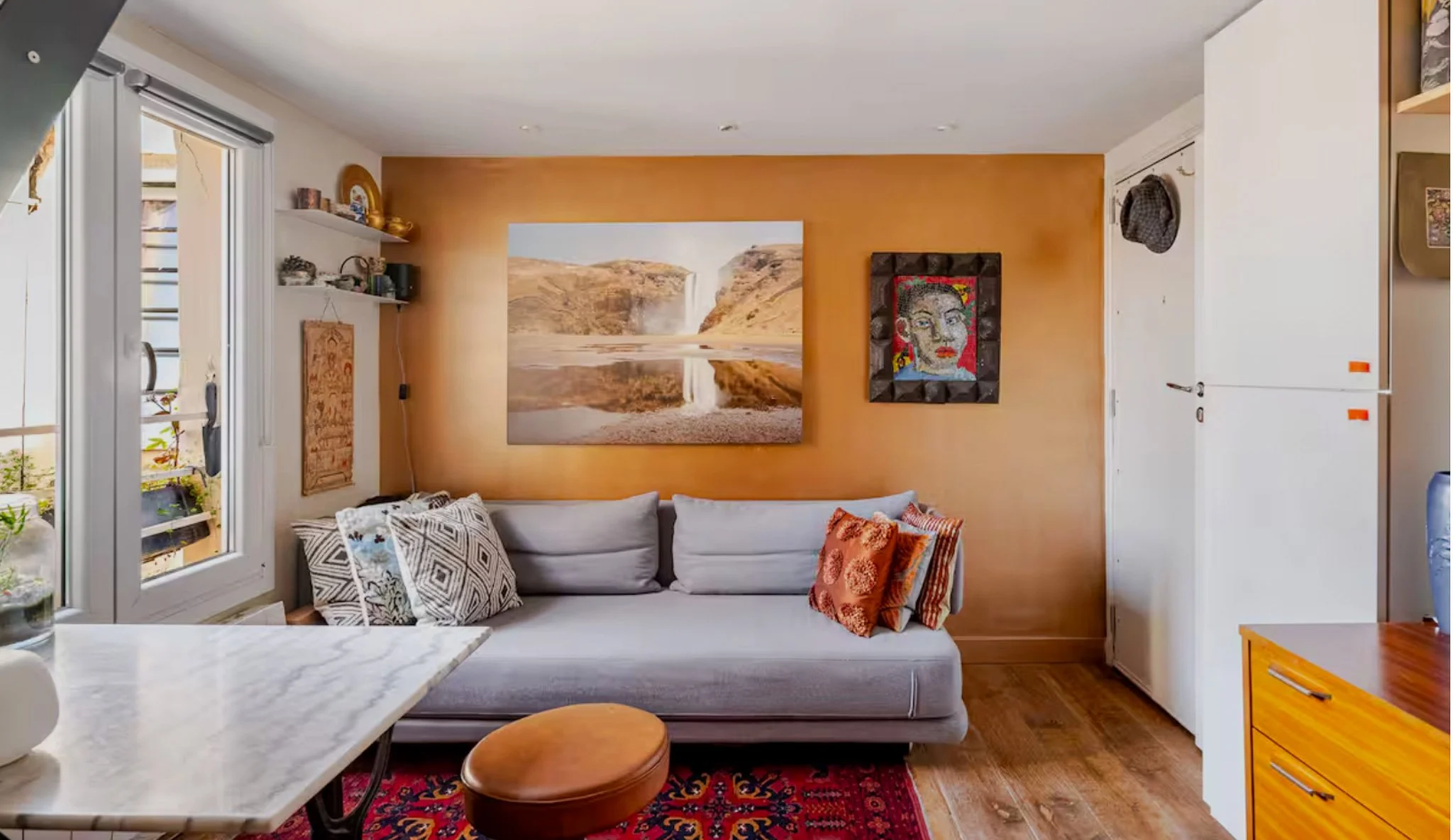 The Zen Guy's 17m² Paris apartment — living room with sleeping loft, full kitchen, and neighborhood views