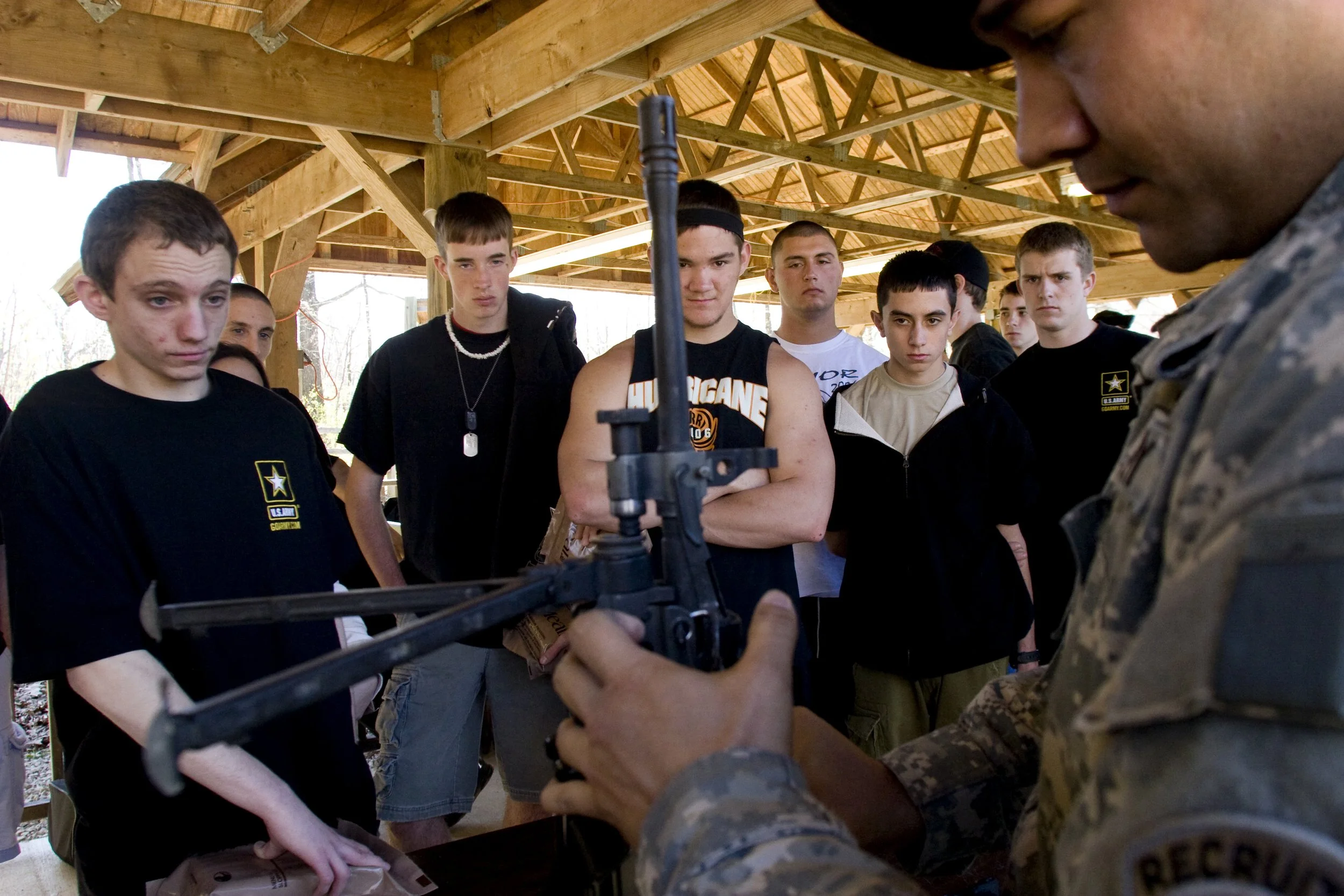 High school seniors get a tutorial on how to break down an assault rifle. They are in a program that allows the boys to enlist before graduation.
