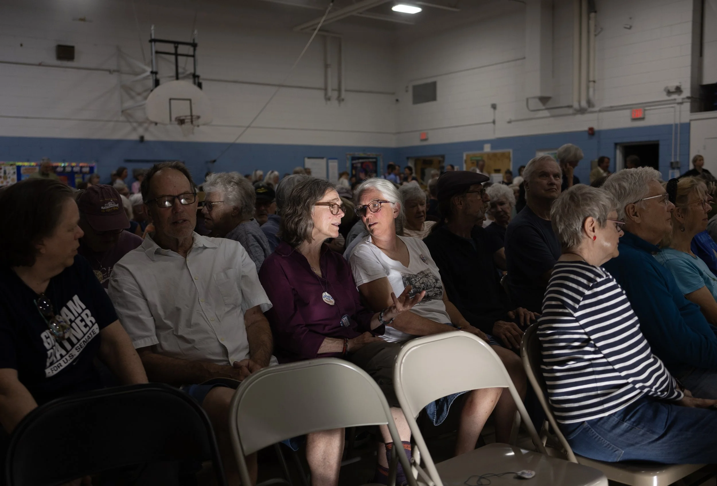 Laurie Burhoe of Phippsburg, right, chats up her neighbor before an event for Democratic candidate Graham Platner  at the Phippsburg elementary school on May 27, 2026.