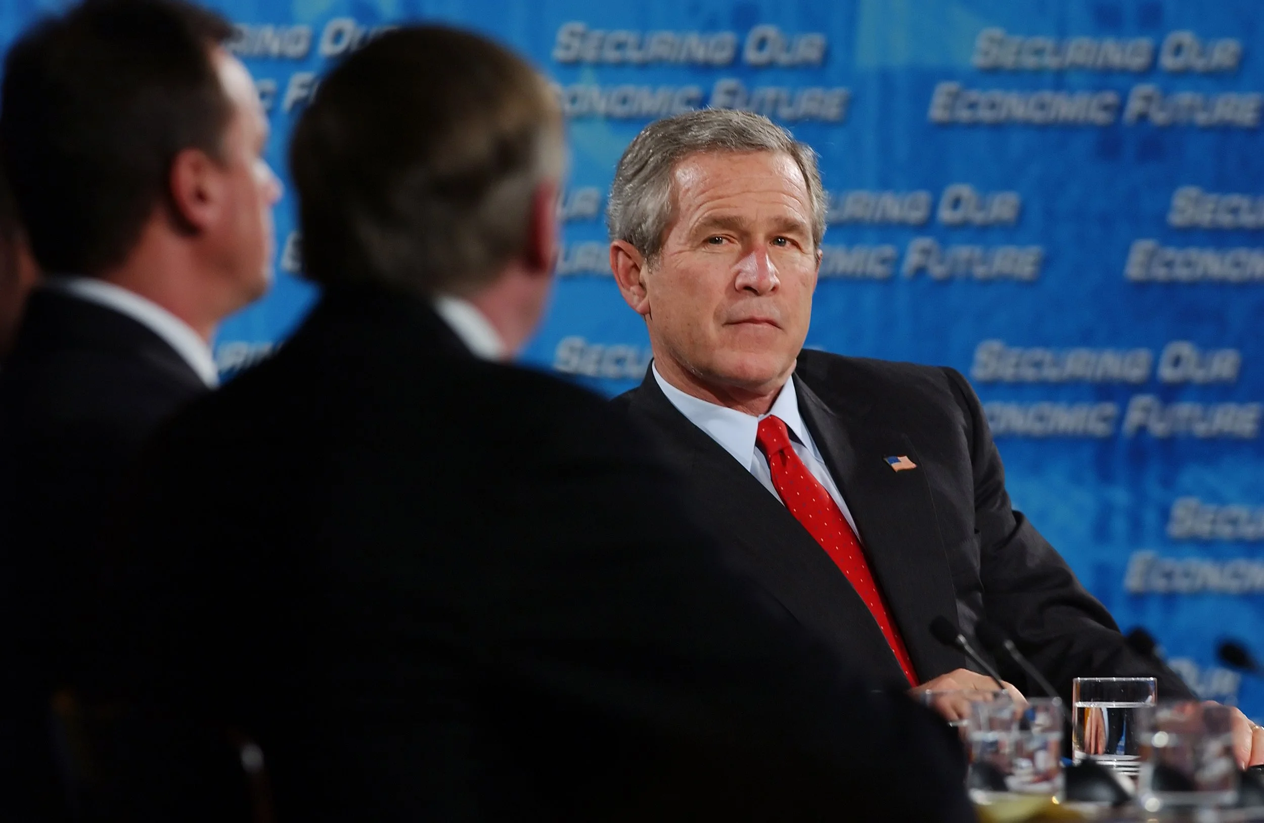President George W. Bush listens to corporate executives and economists during the closing of the two-day White House Conference on the Economy on December 16, 2004.