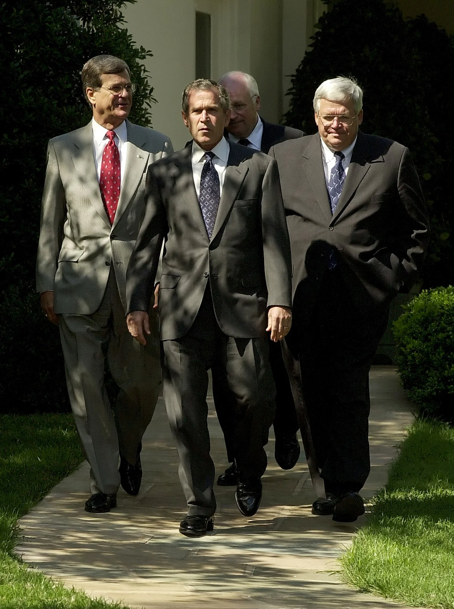 President George W. Bush marches out of the Oval Office with Speaker of the House Dennis Hastert and Senate Minority Leader Trent Lott at the White House.