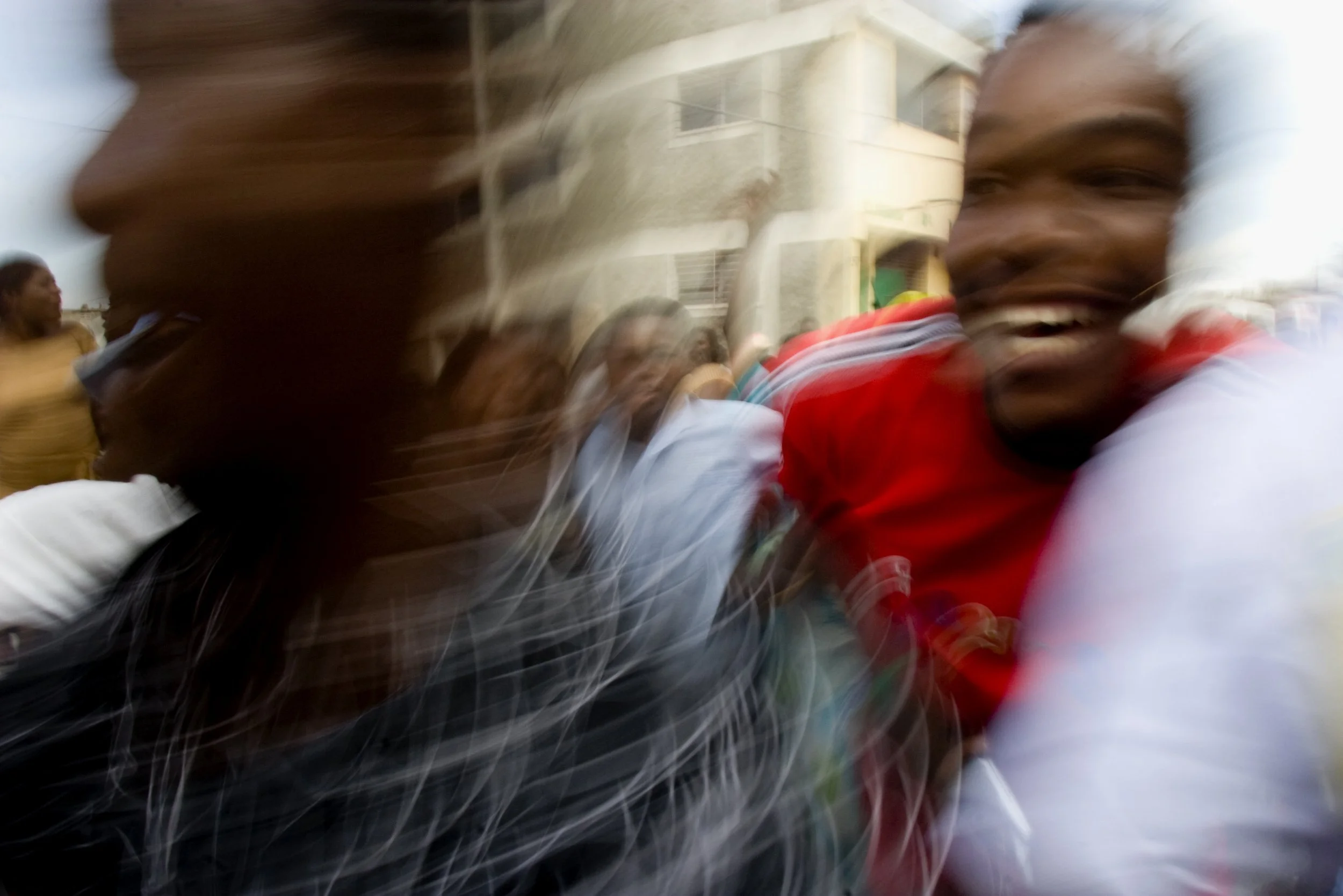 During a rally weeks before the national election, supporters of President René Garcia Préval pour through the streets of Port-au-prince, Haiti.