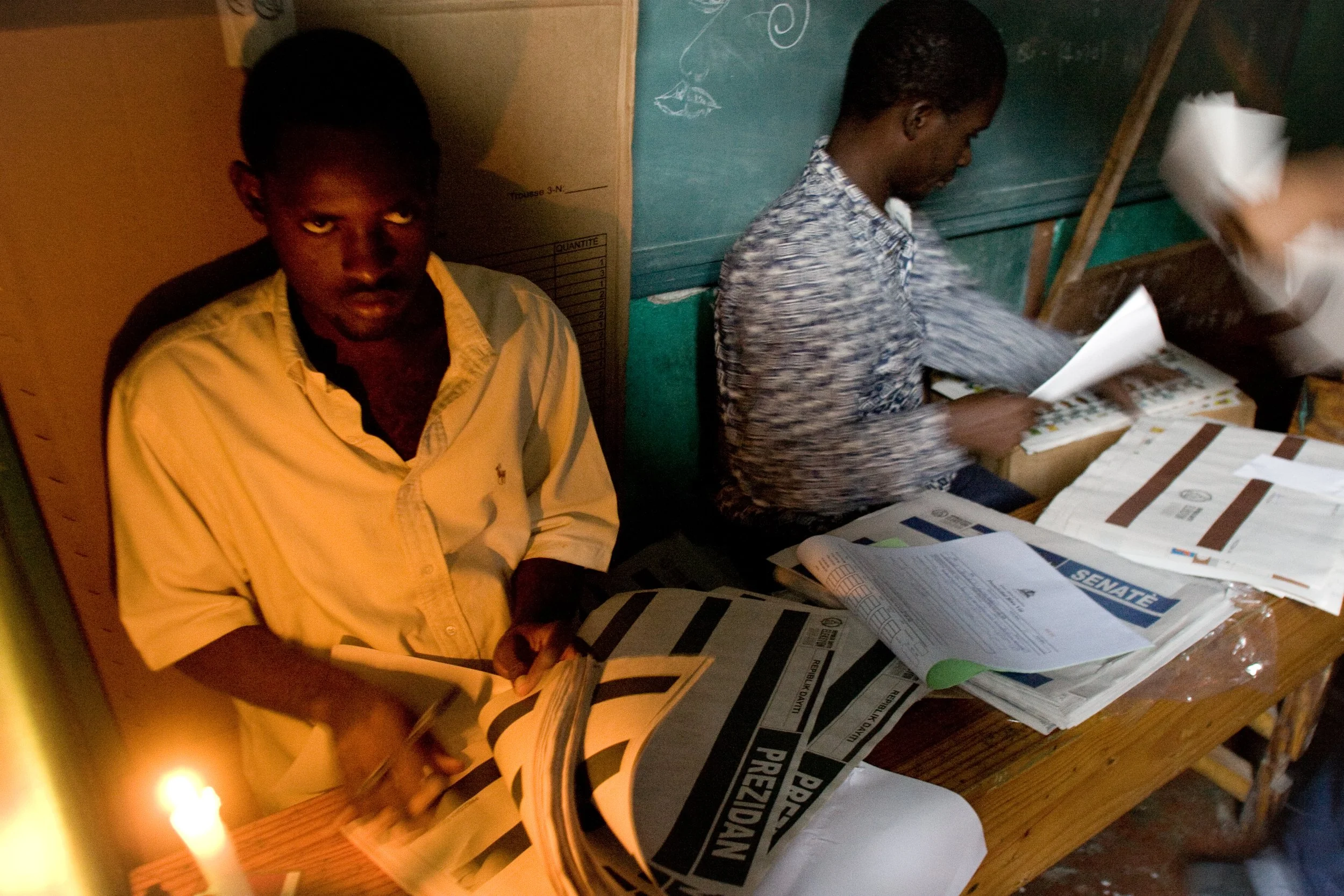 Election day begins early and by candlelight in Port-au-Prince, Haiti.  People are excited but wary of what the next few days will bring.