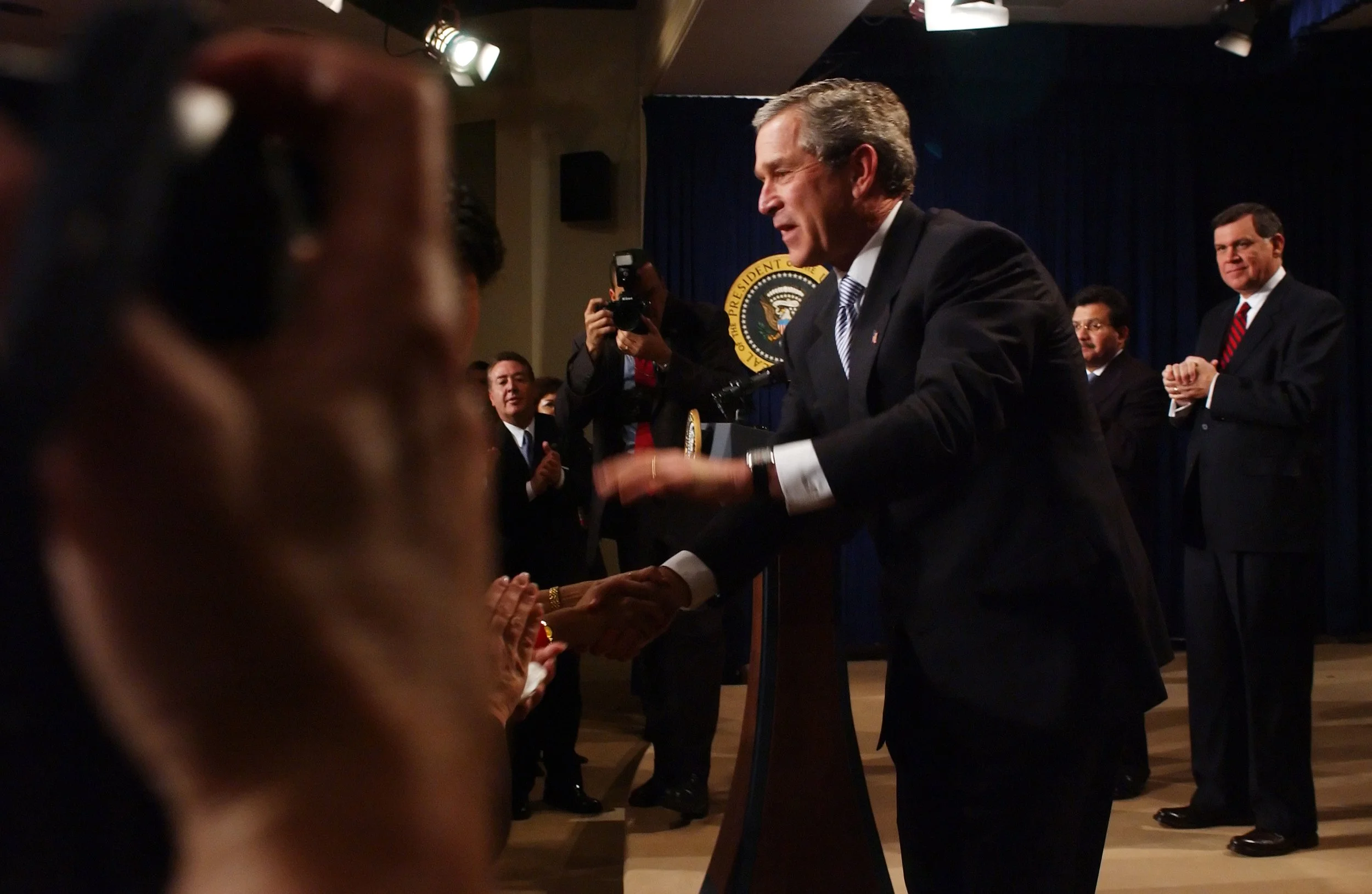 President George W. Bush shakes hands with staff and guests after giving a policy address at the White House.