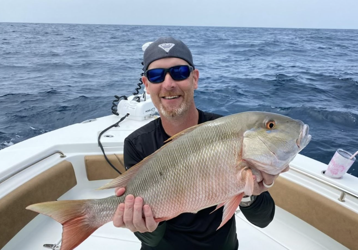 Man holding a mutton snapper offshore st augustine florida