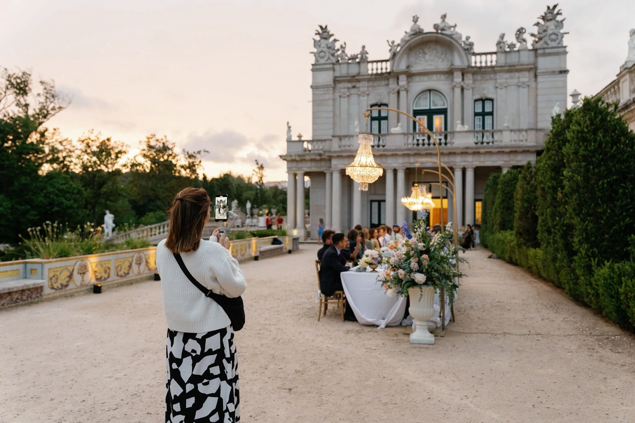 Wedding content creator filming destination wedding at sunset in Portugal palace