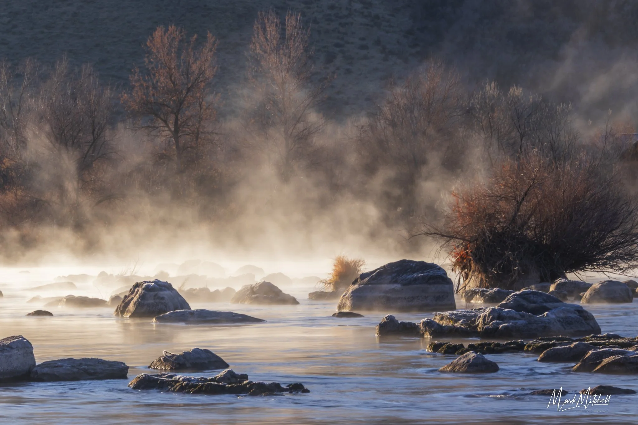 Sun lighting up steam fog on the Snake River