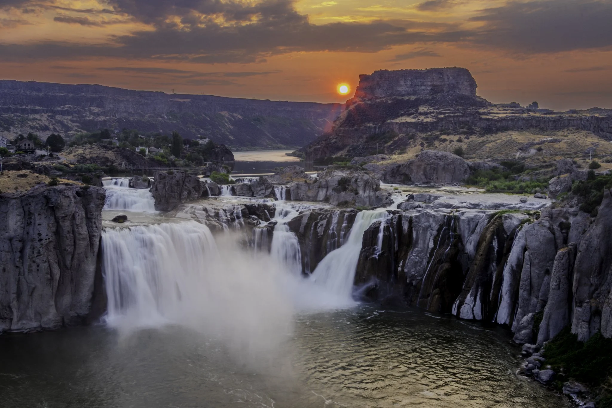 Smoke from mid July wildfires create a subdued and hazy sunrise over the splendid Shoshone Falls in Twin Falls.