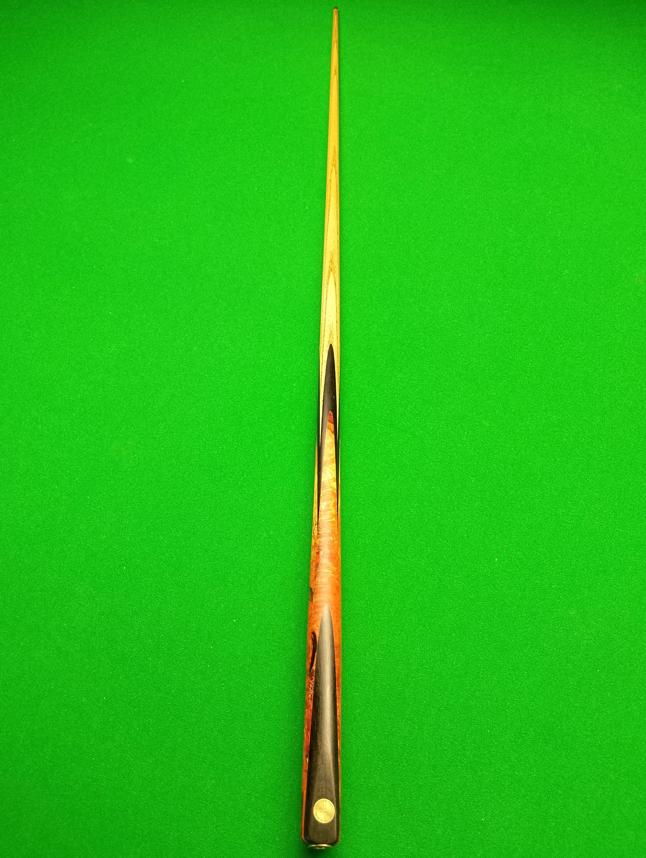 A cue stick on a green snooker or pool table.