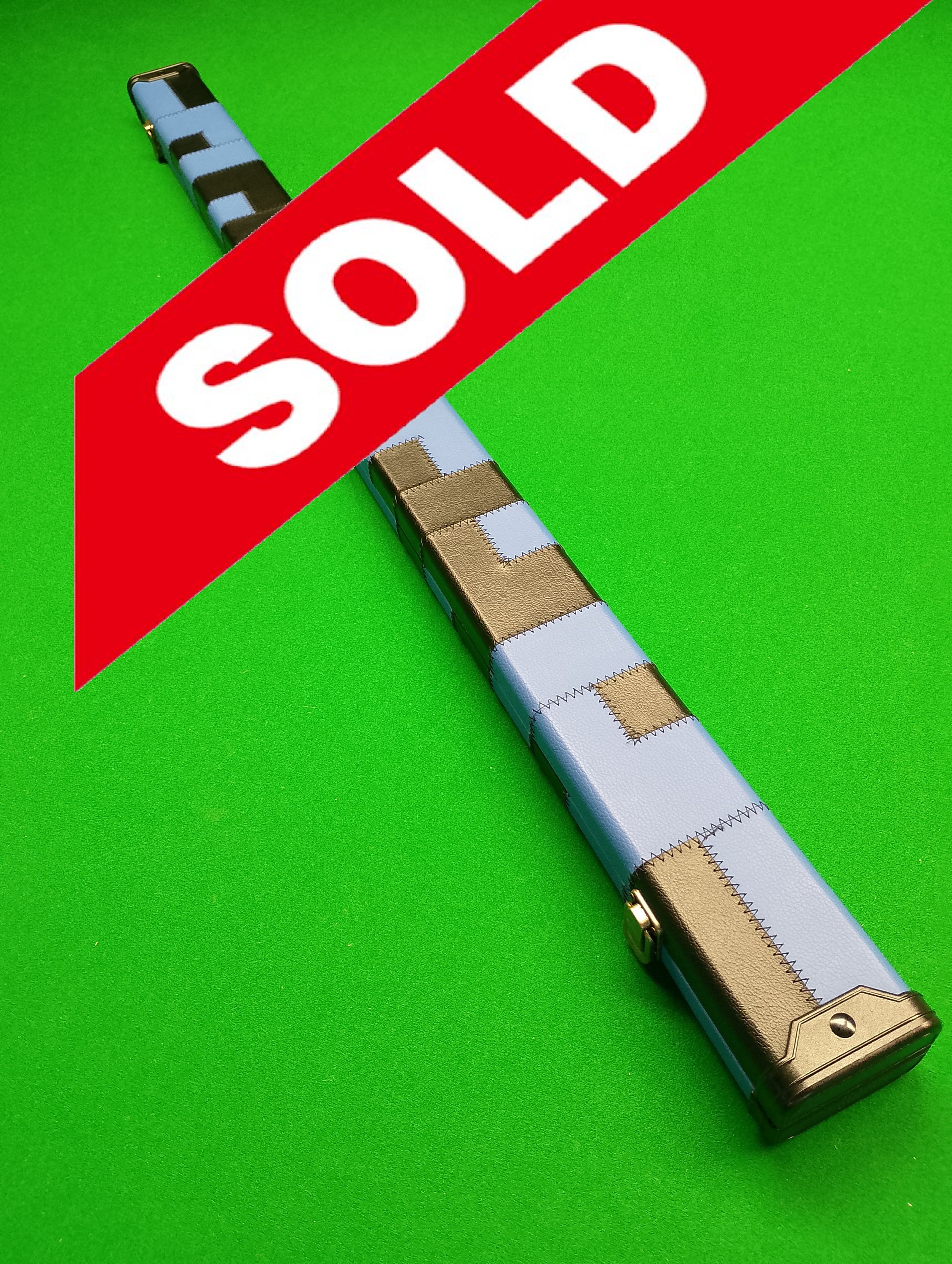 A poker chip case on a green felt table with a large red 'SOLD' banner across it.