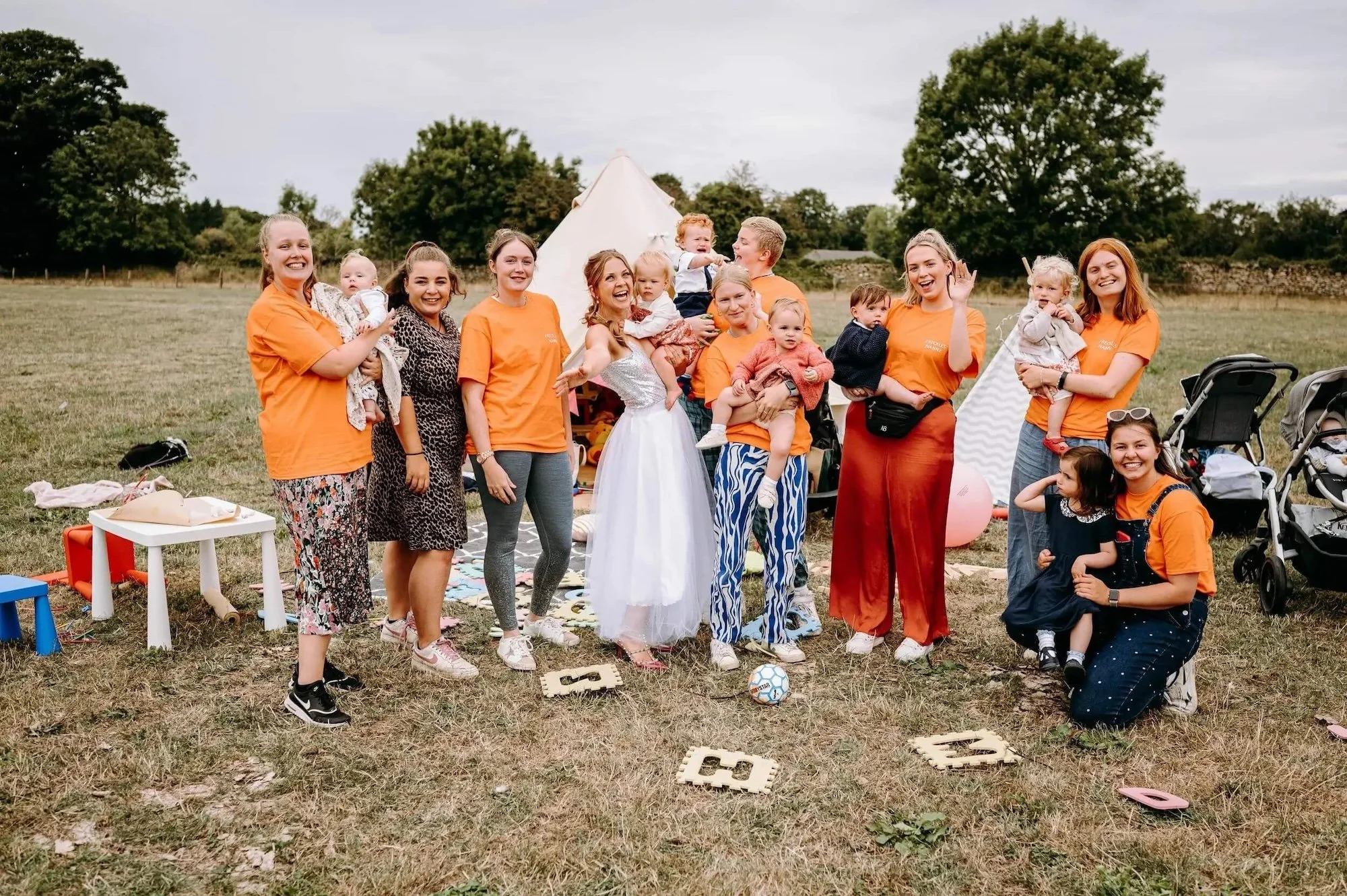 Wedding nanny team looking after children alongside the bride at a wedding