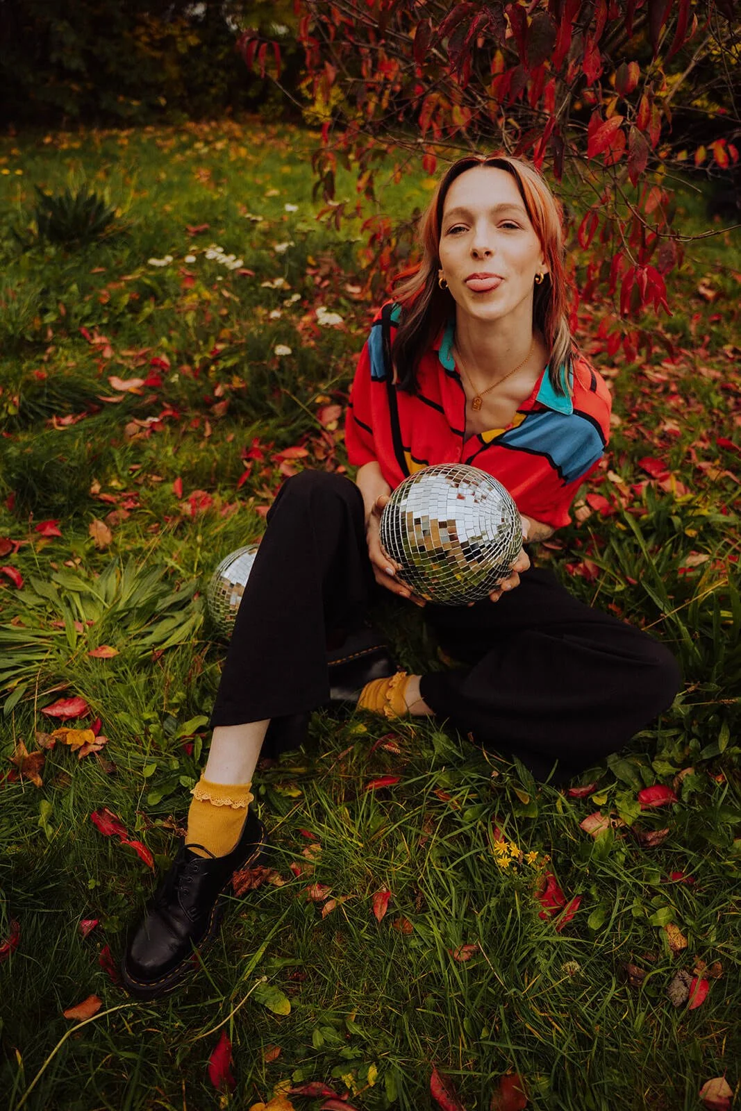 Portrait of wedding singer in Bristol holding a disco ball.