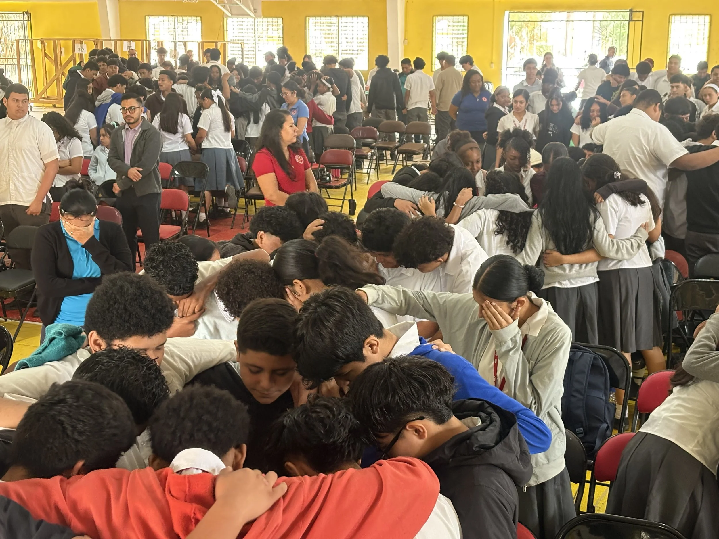 Large group of people receiving prayer