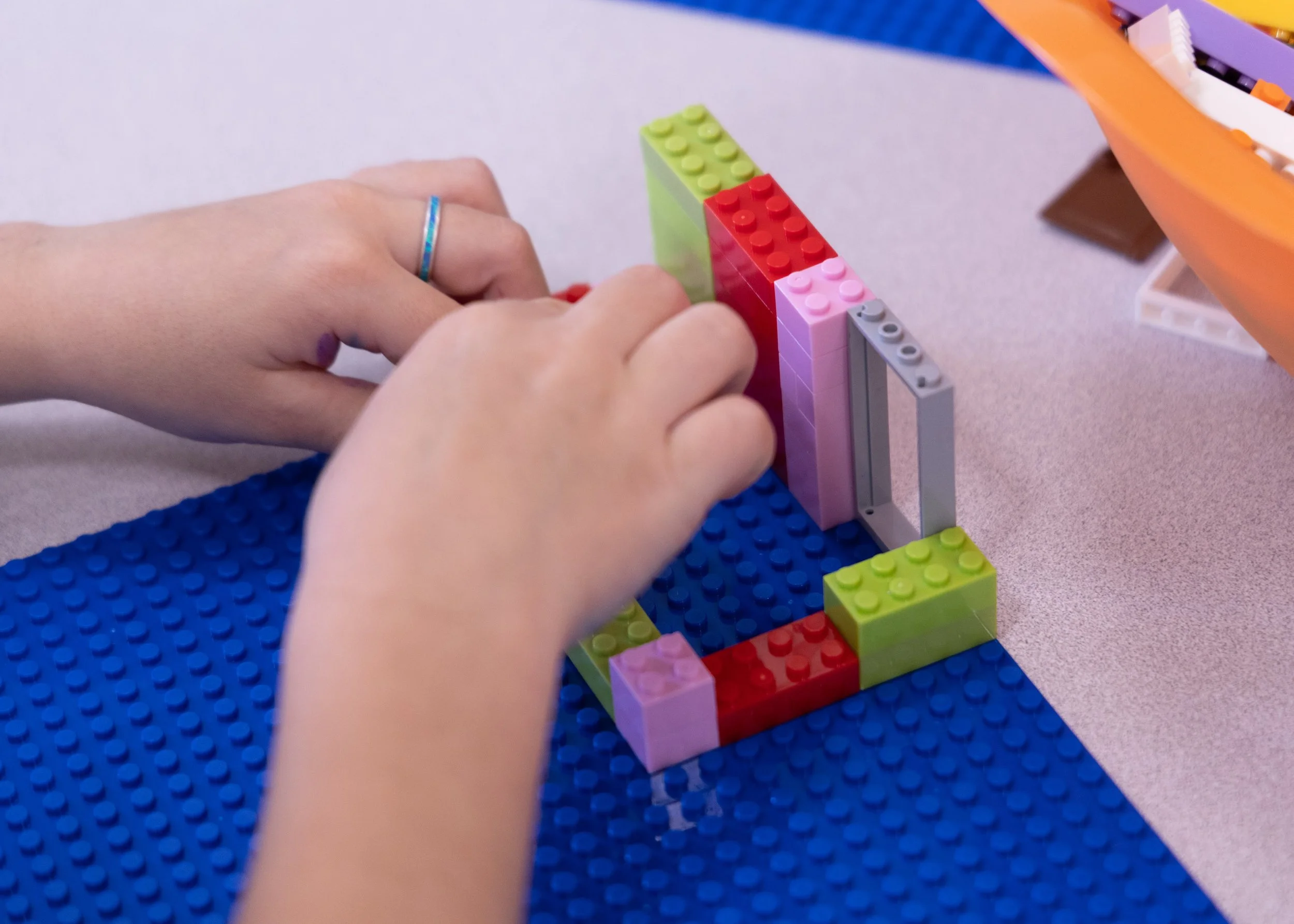 Picture of child's hands building legos