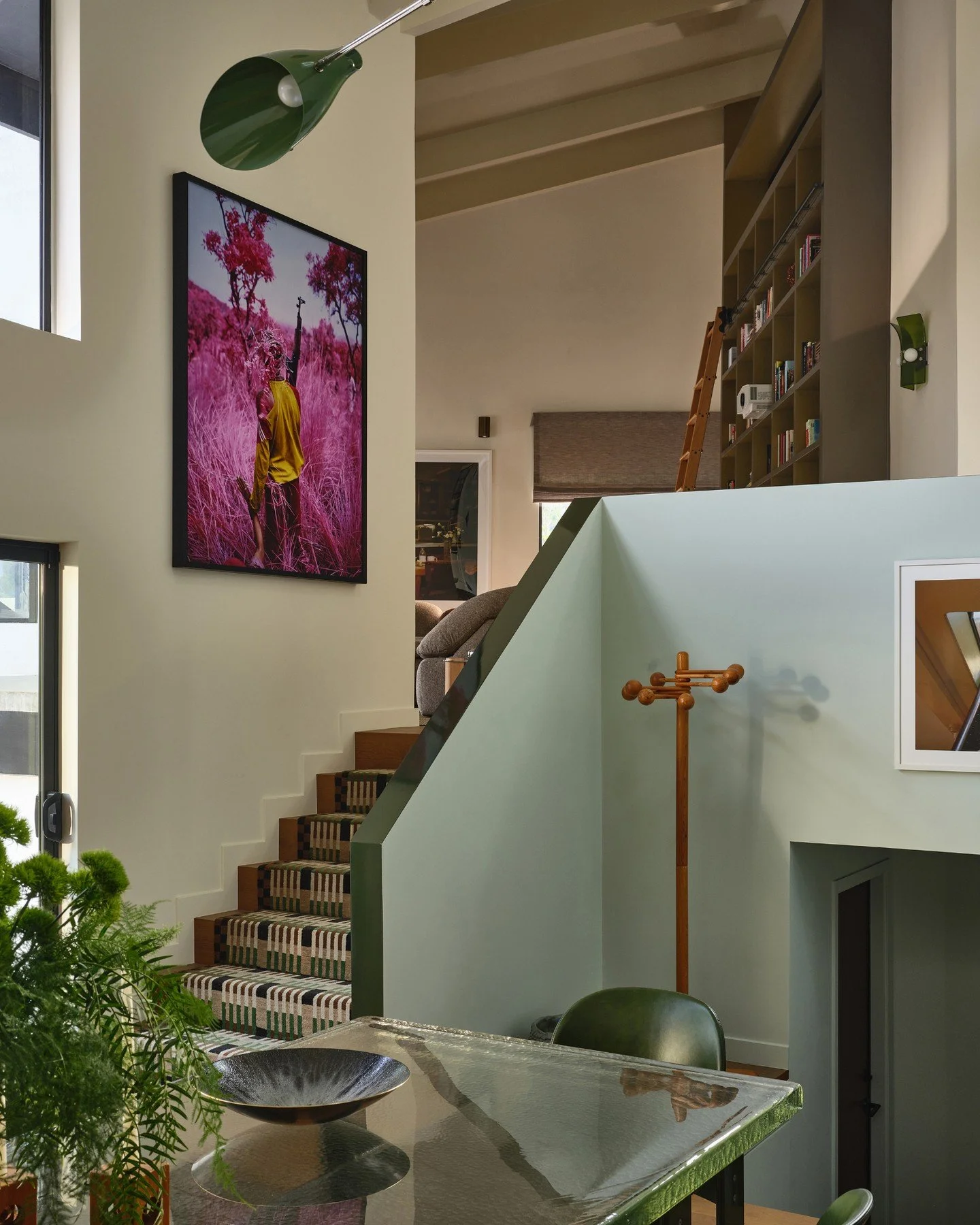 Upon entering the home, you&rsquo;re immediately drawn into the kitchen, where the architecture of the main space unfolds. To emphasize its sculptural geometry, the walls are boldly color-blocked&mdash;an intentional gesture inspired by the layered m