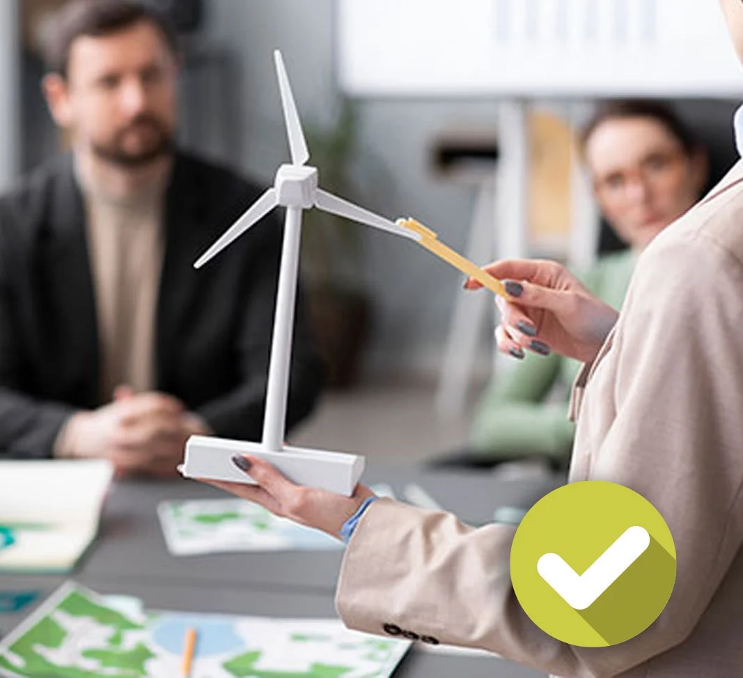 blurred shot of 3 people discussing a wind turbine