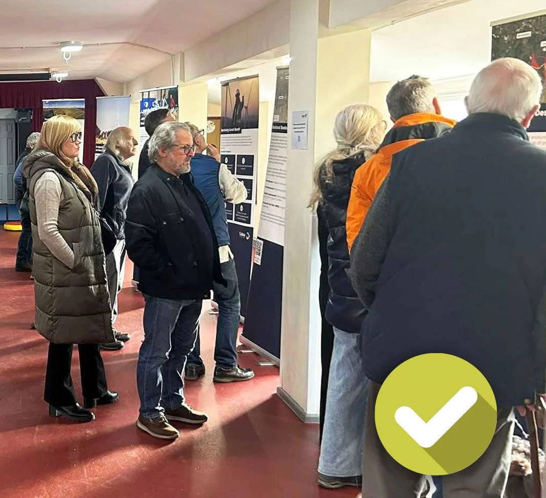 Members of the public reviewing large graphics