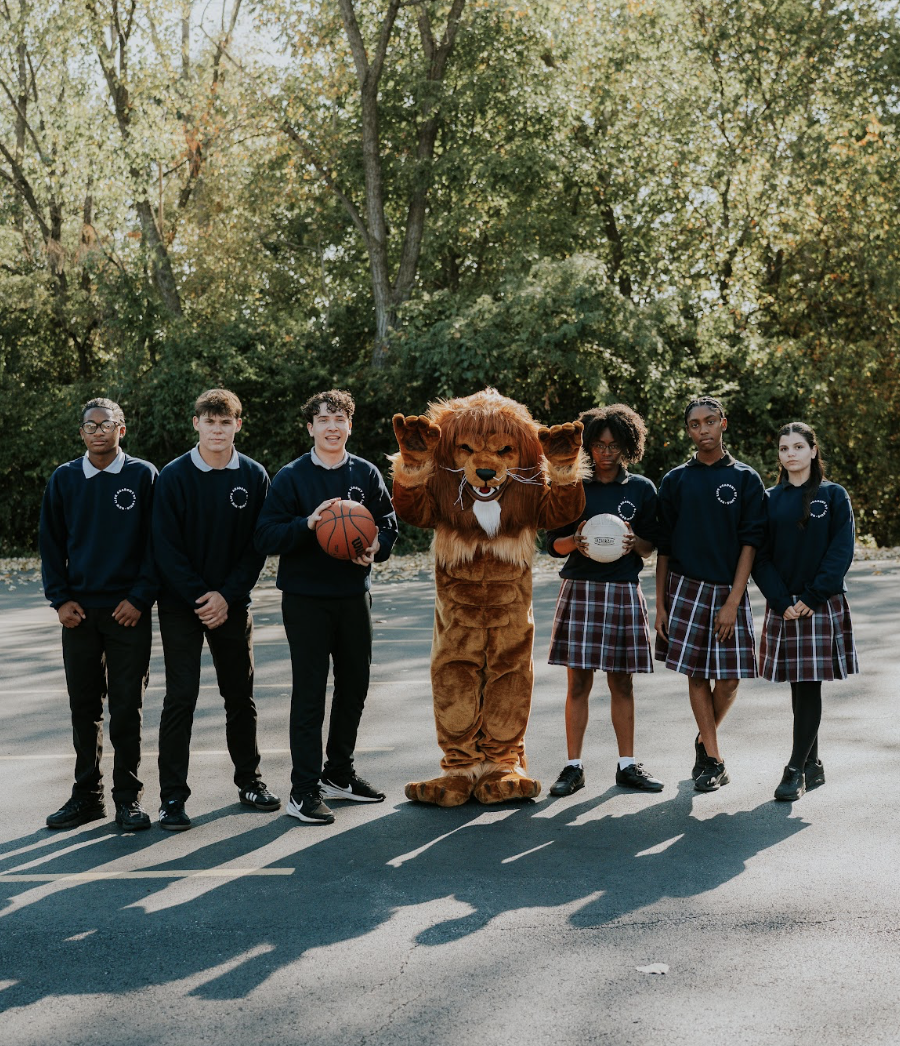 New Life Academy high school students with the school mascot