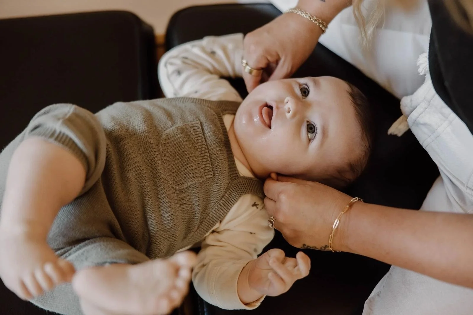 Dr. Jennifer Gordon holding and adjusting a baby's jaw/neck area