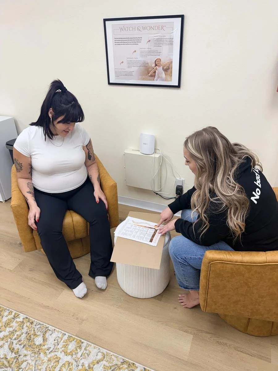 Dr. Jennifer Gordon reviewing a care plan with a prenatal chiropractic patient at Taproot Chiropractic.