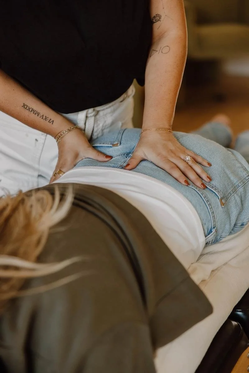 Dr. Jennifer Gordon adjusting a pregnant patient's lower back on the treatment table