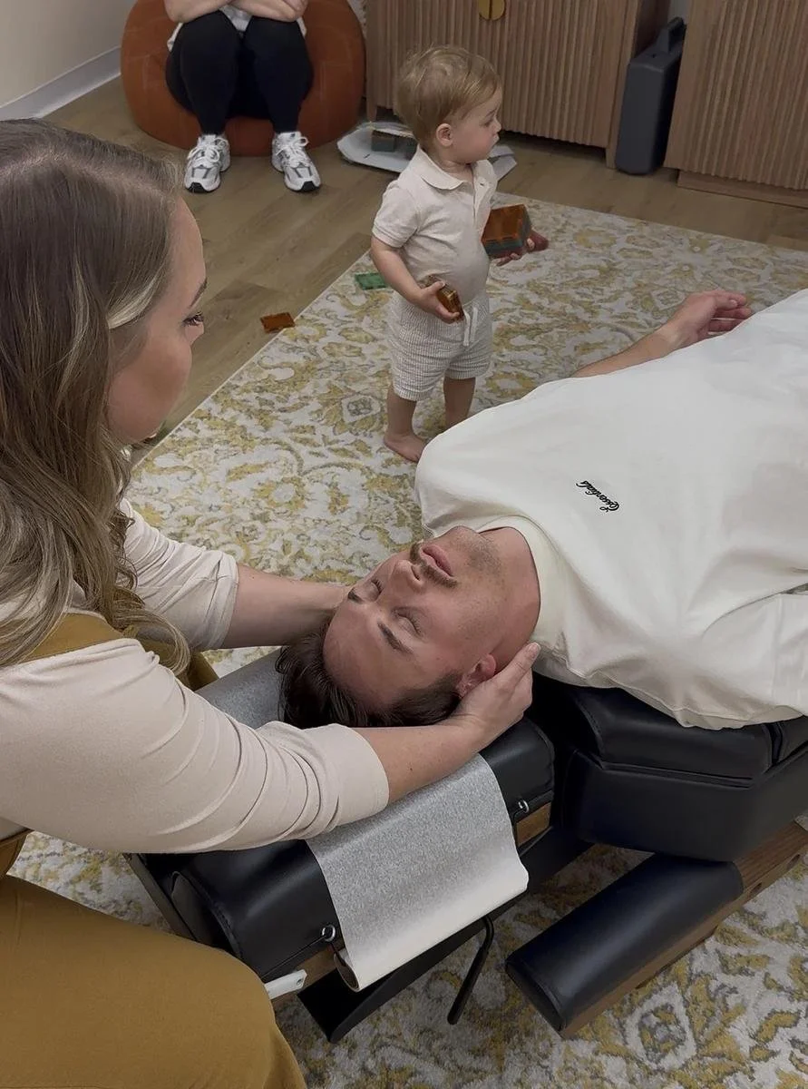 Dr. Jennifer Gordon providing a side-lying chiropractic adjustment to an adult patient at Taproot Chiropractic.