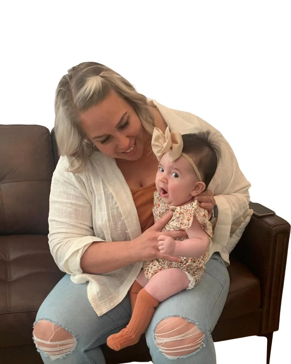 Mother holding and comforting her infant while seated.
