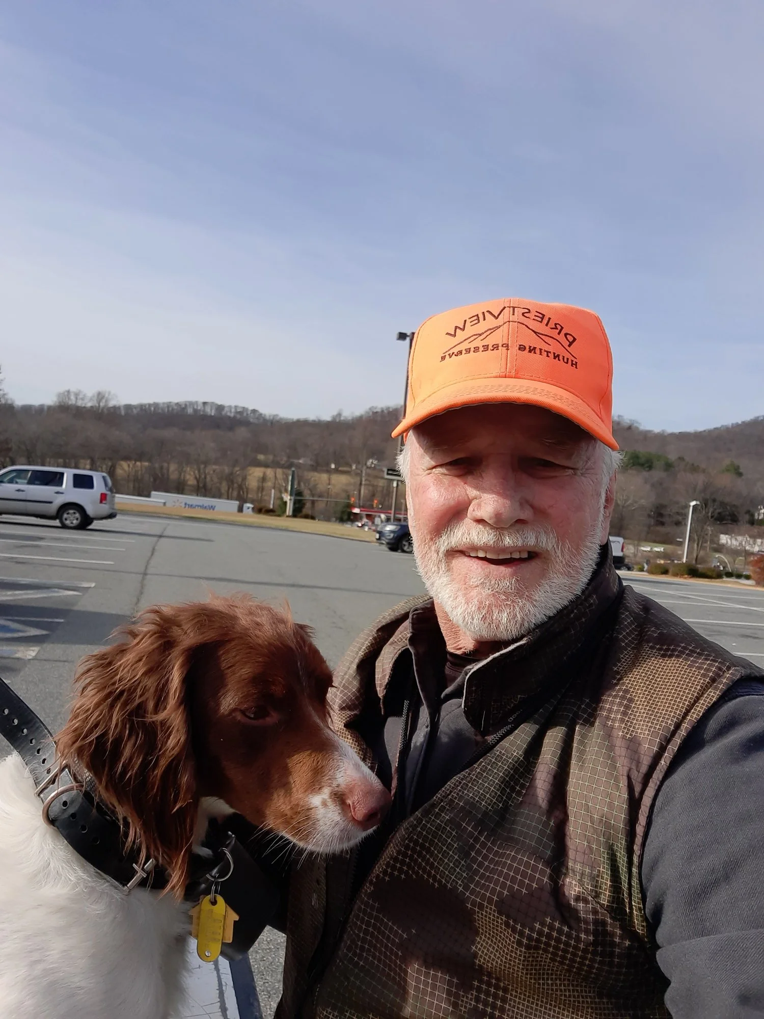 Photo of Bill McDonald in a Blaze PriestView hat with a Brittany