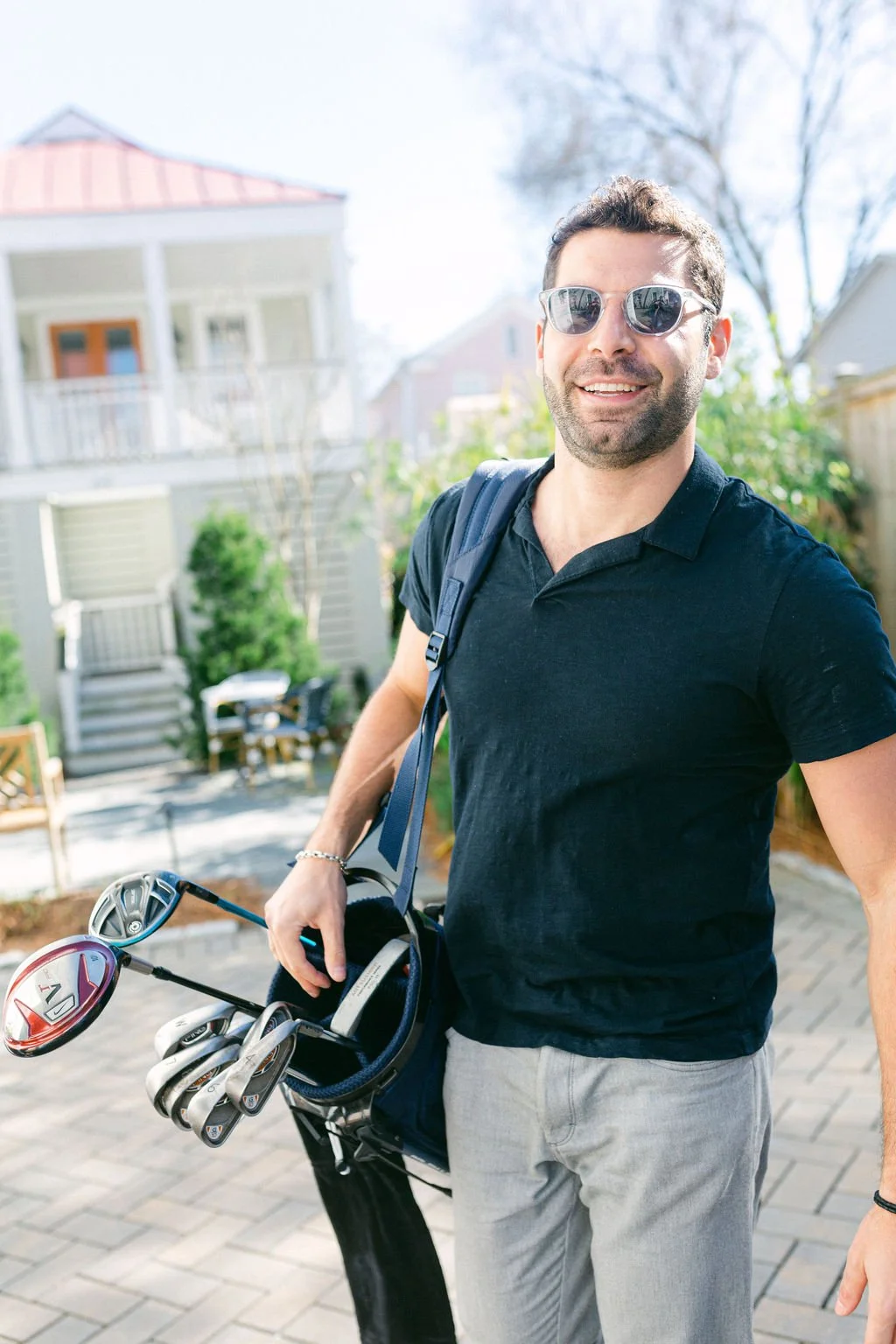 Guest arriving at a historic Charleston vacation home with golf clubs