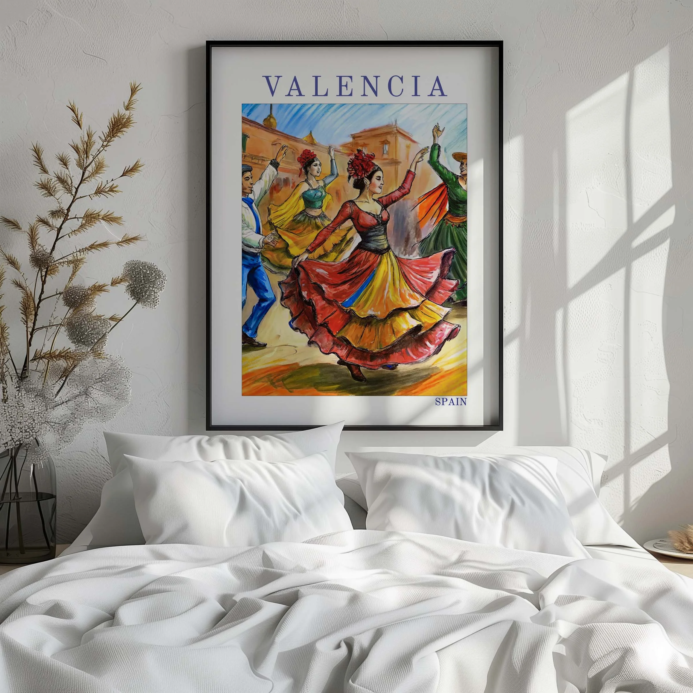 A framed vibrant painting of traditional Spanish dancers in colorful dresses, hanging on a white wall above a bed with white pillows and bedding, with sunlight casting shadows on the wall.