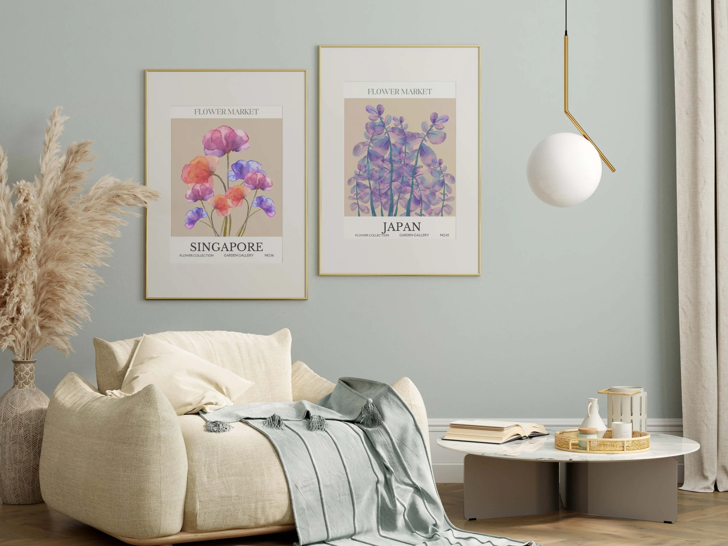 Living room with a light beige sofa, a round marble coffee table, framed artwork of flowers on the wall, a hanging light fixture, a vase with pampas grass, and a window with curtains.
