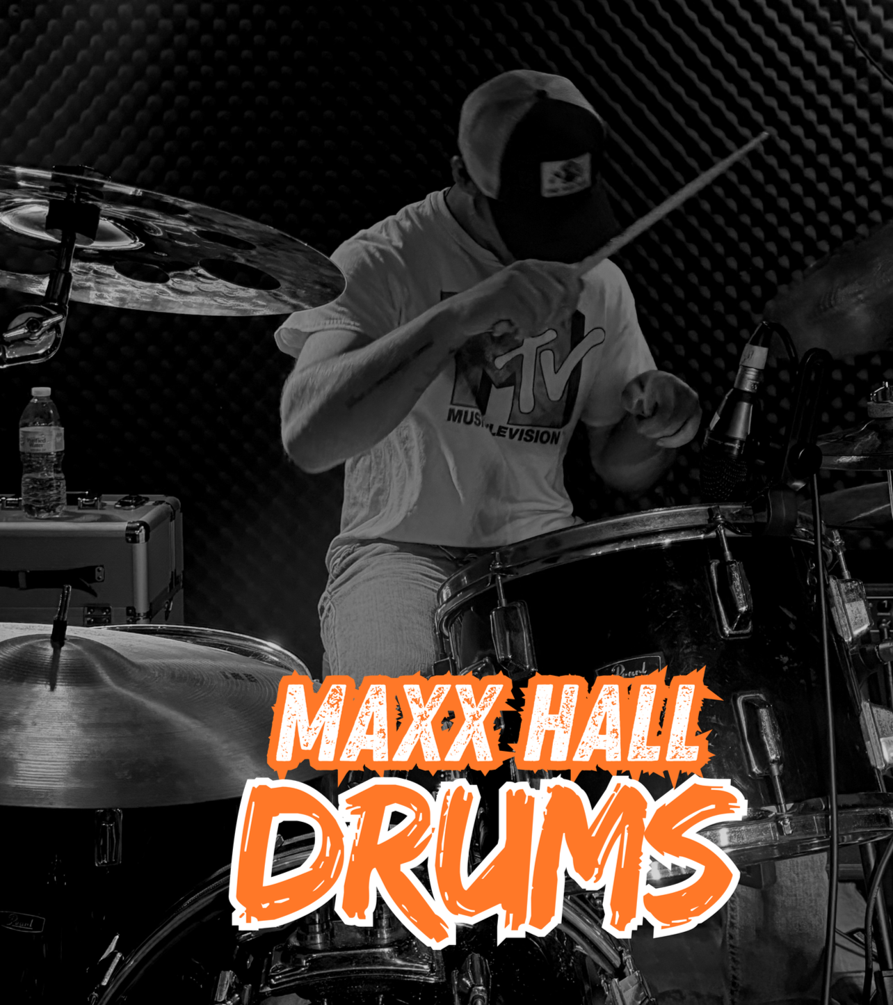 A person playing drums in a music studio, wearing a cap and a MTV t-shirt, with text overlay that says "MAXX HALL DRUMS" in bold orange letters.