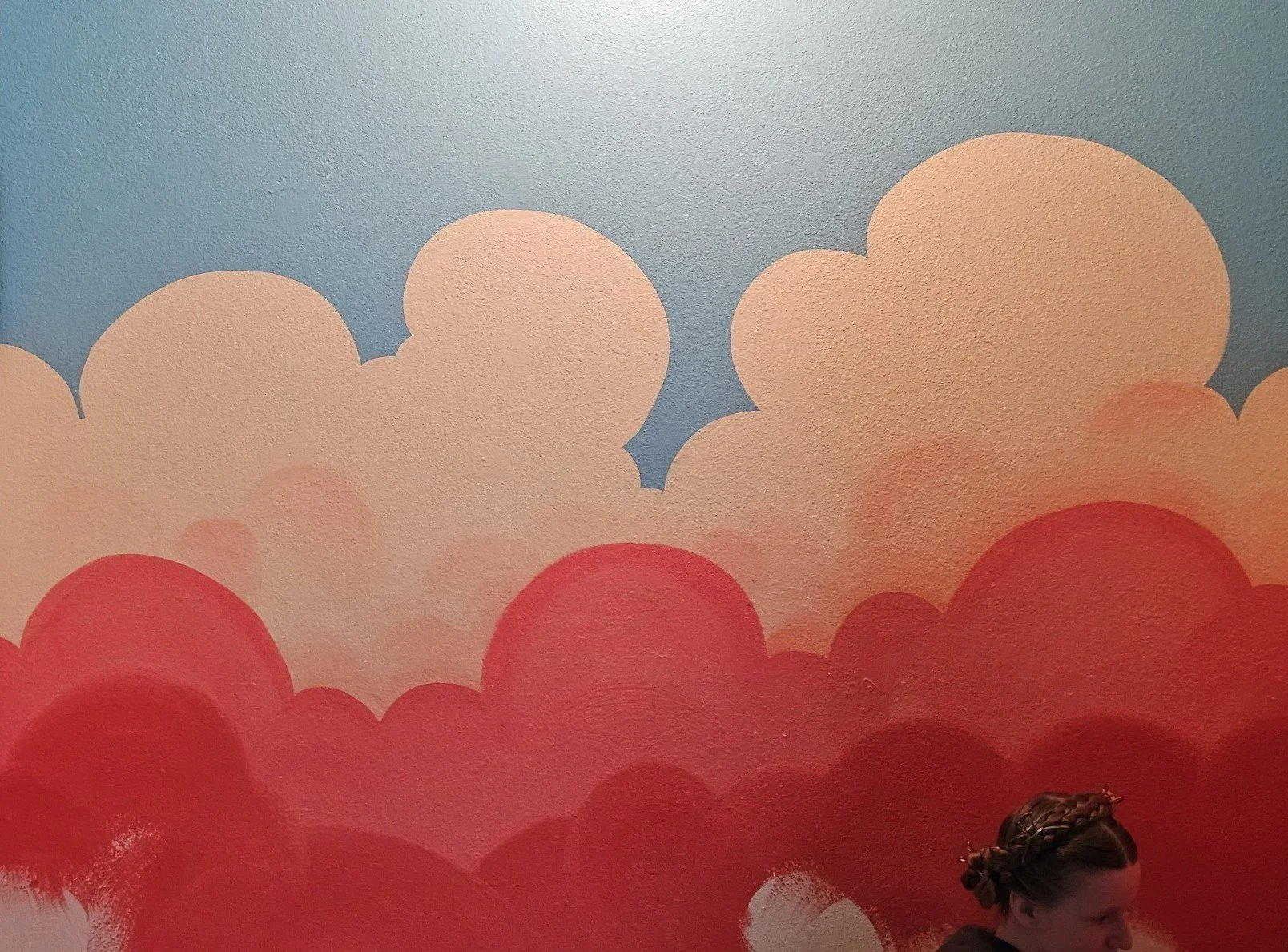 Photo of Sierra painting the Nursery Mural