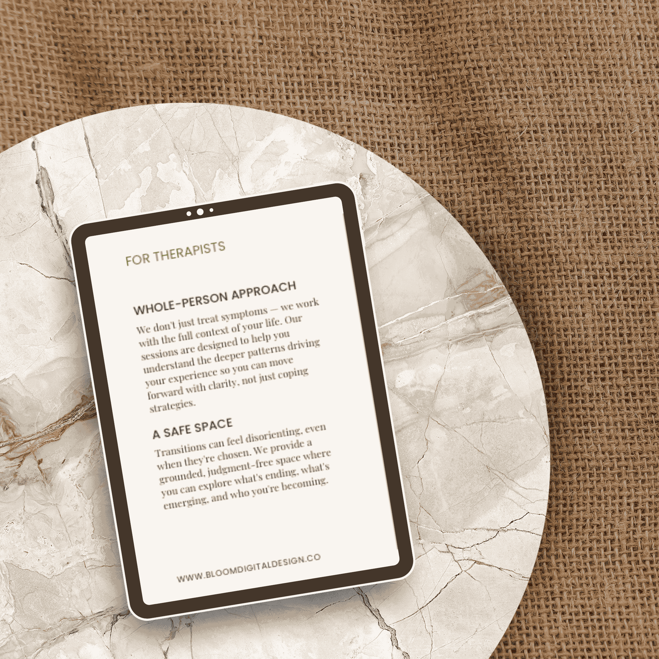Close-up of a smartphone screen displaying text about therapy approaches, resting on a marble surface with a woven fabric background.