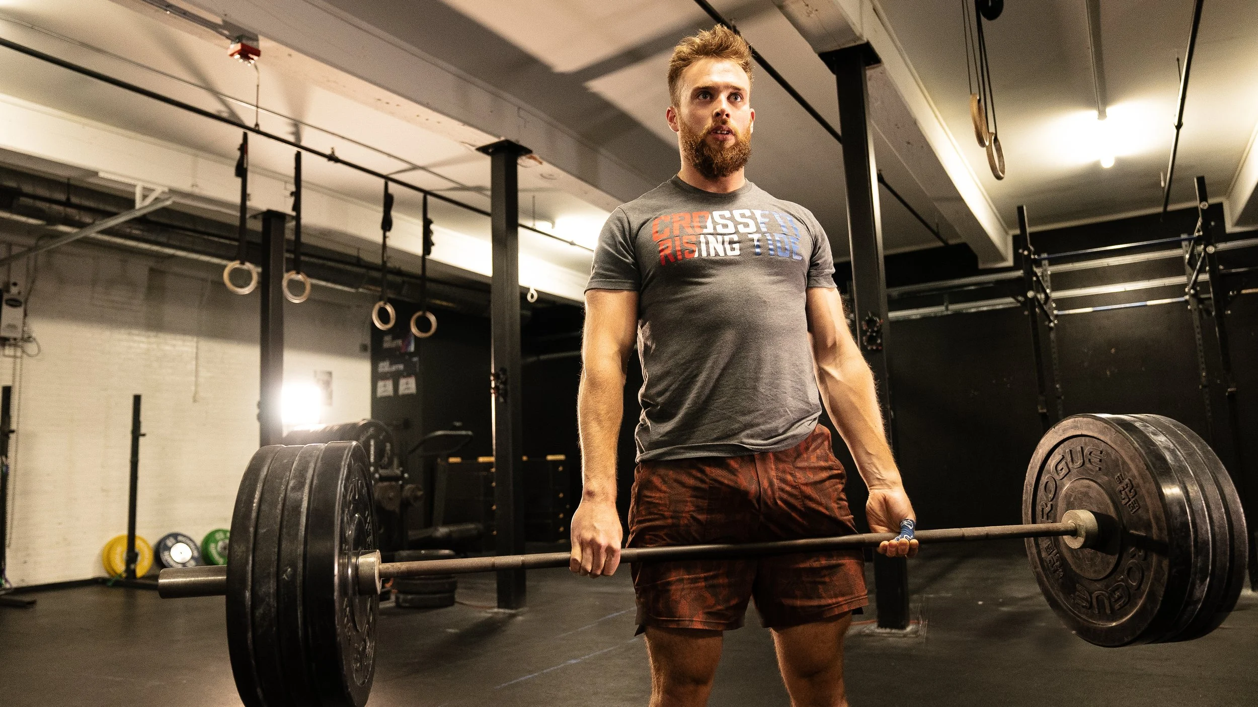 Man lifting barbell in gym