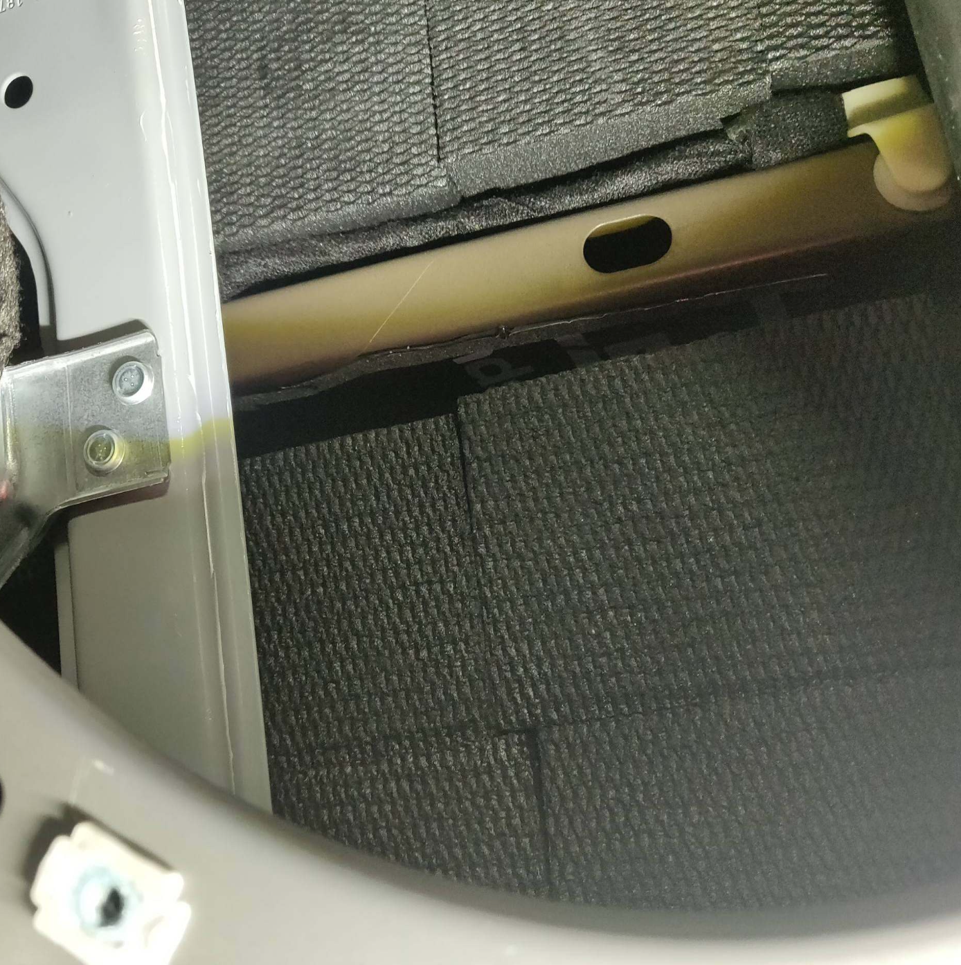 Blackhole Mat installed behind a car door panel for vibration and rattle control.
