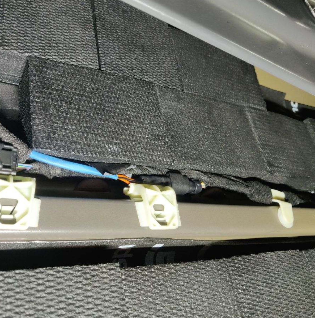 Blackhole Mat installed behind a car door panel for vibration and rattle control.