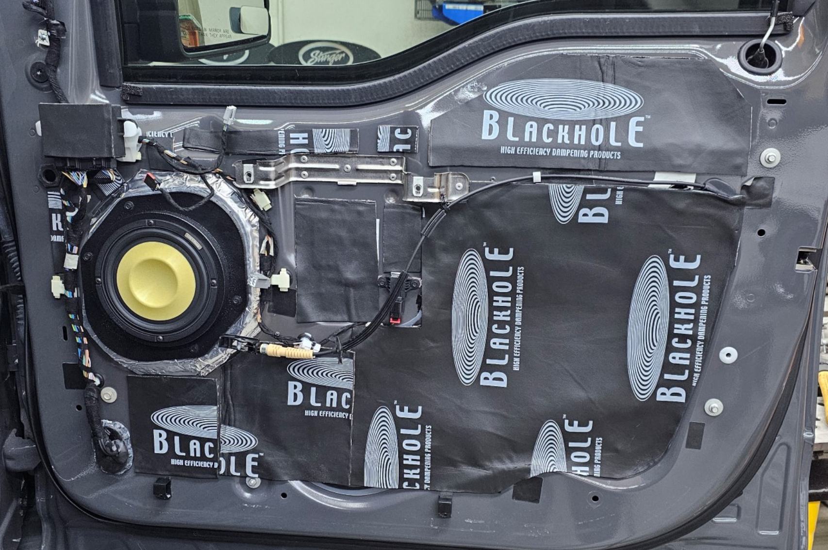 Vehicle door sound treated using Blackhole Mat and Blackhole Tile to control resonance, stop panel vibration, and improve midbass clarity.