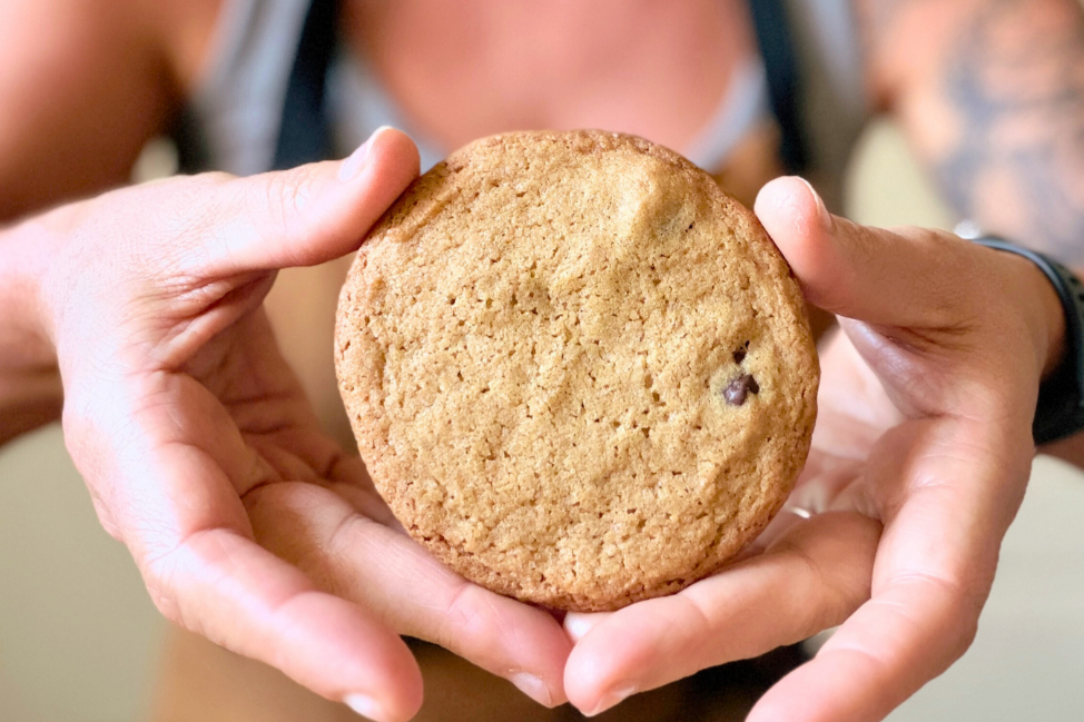 Rose Cameron holding crispy chocolate chip cookie