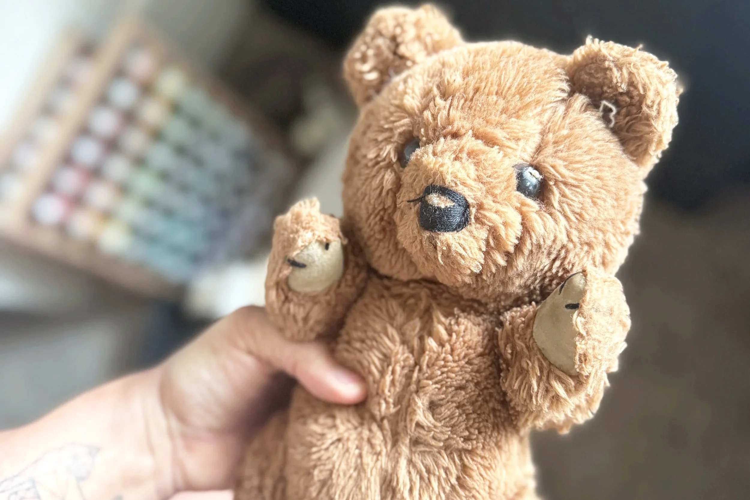 Small threadbare bear toy