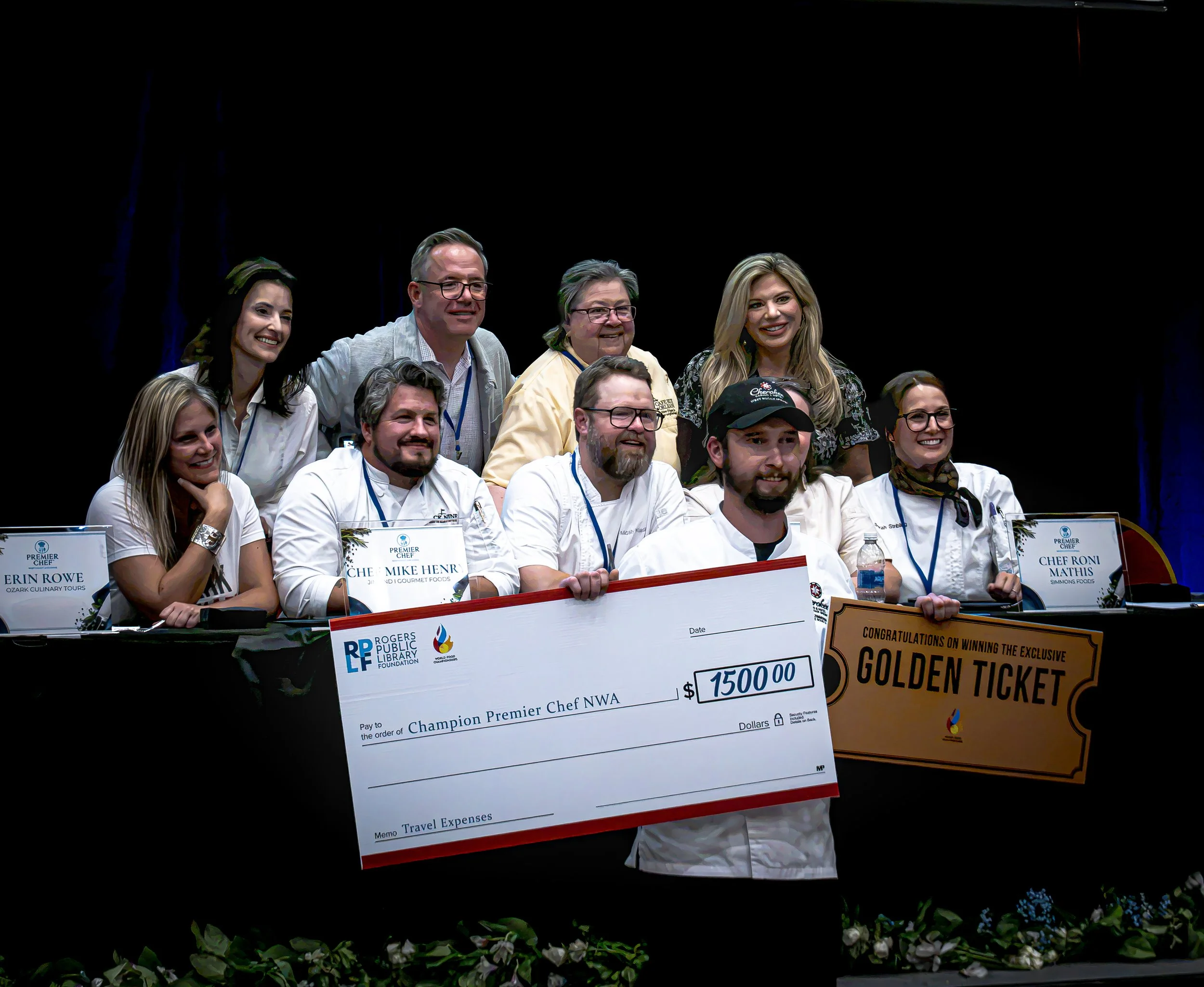 Premier Chef Northwest Arkansas 2026 champion pictured with fellow chefs and judges during the awards ceremony at the Rogers Convention Center, with a $1,500 prize check and Golden Ticket.