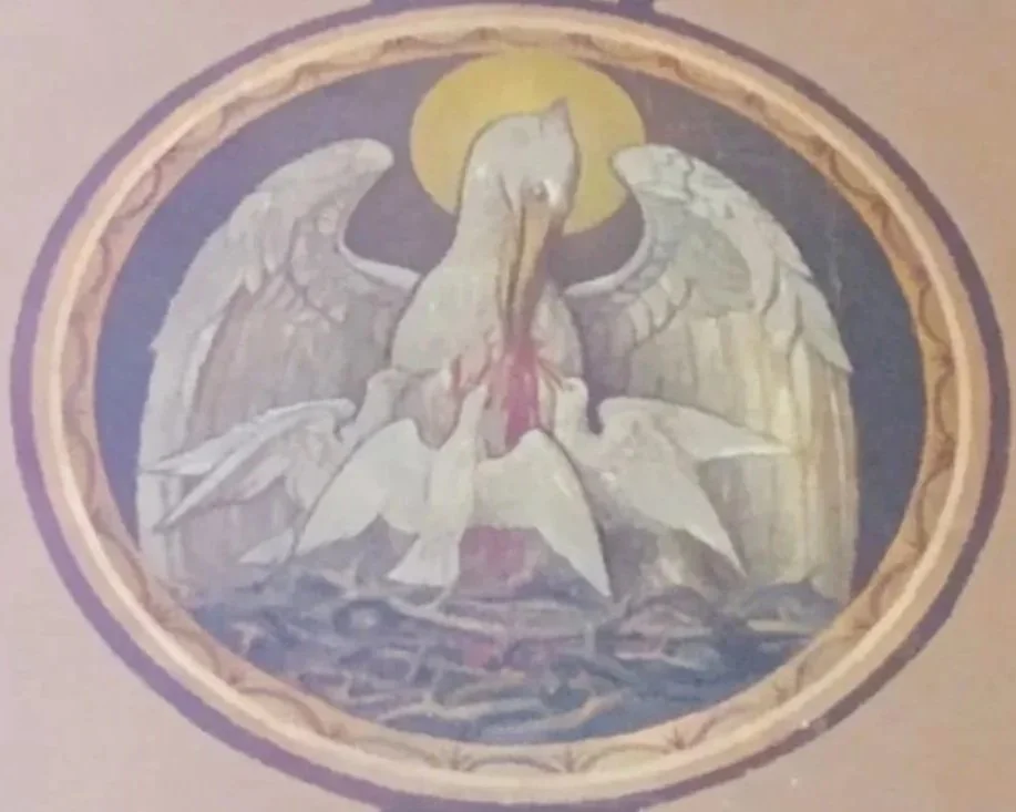 A religious stained glass window depicting a white dove with an olive branch in its beak, a halo, and a blue background.