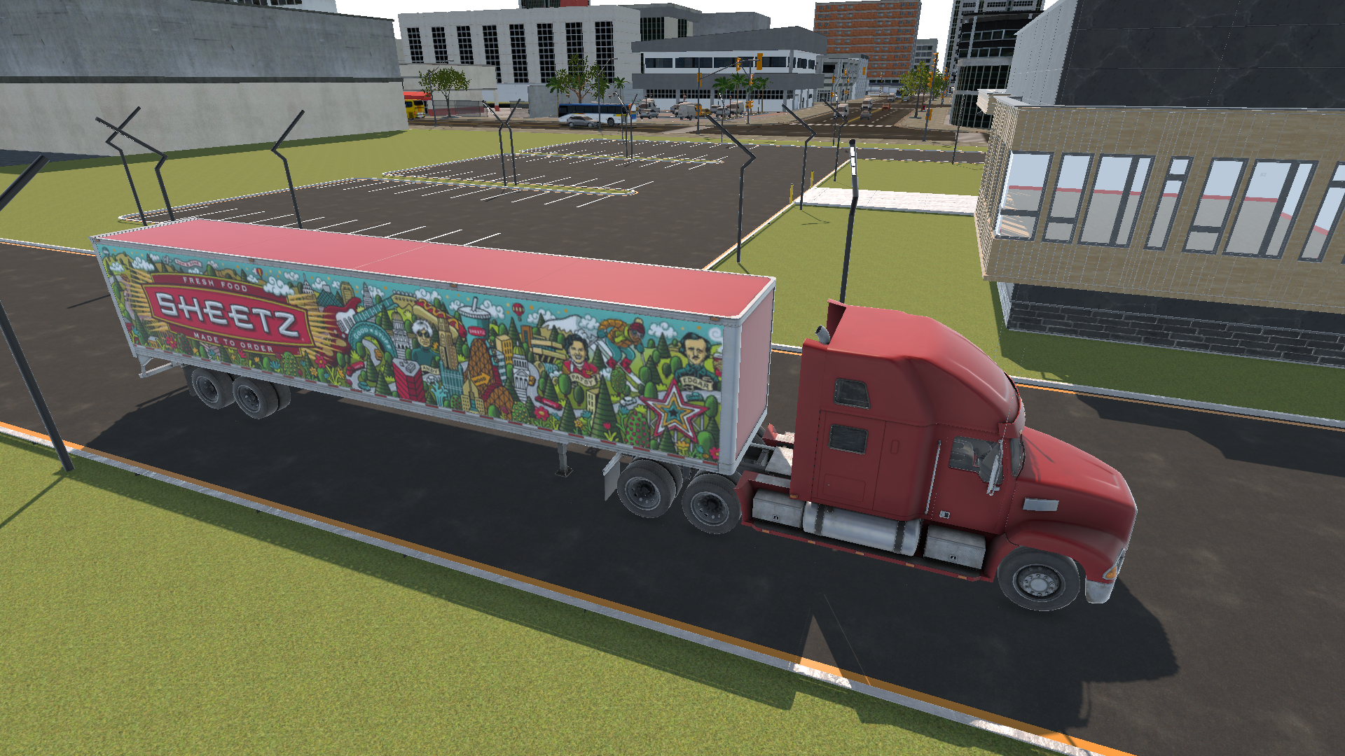 A red semi-truck with colorful artwork on the trailer, parked on a city street near a parking lot and modern buildings.