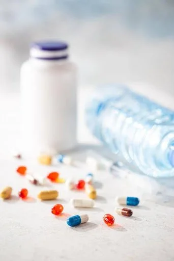 Assorted medical pills lying on table