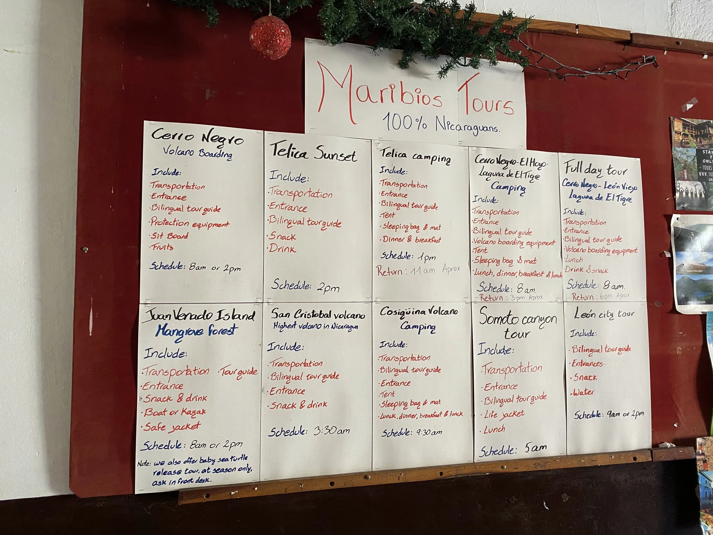 Tour board in Nicaragua showing prices for volcano boarding, island tours, and local excursions
