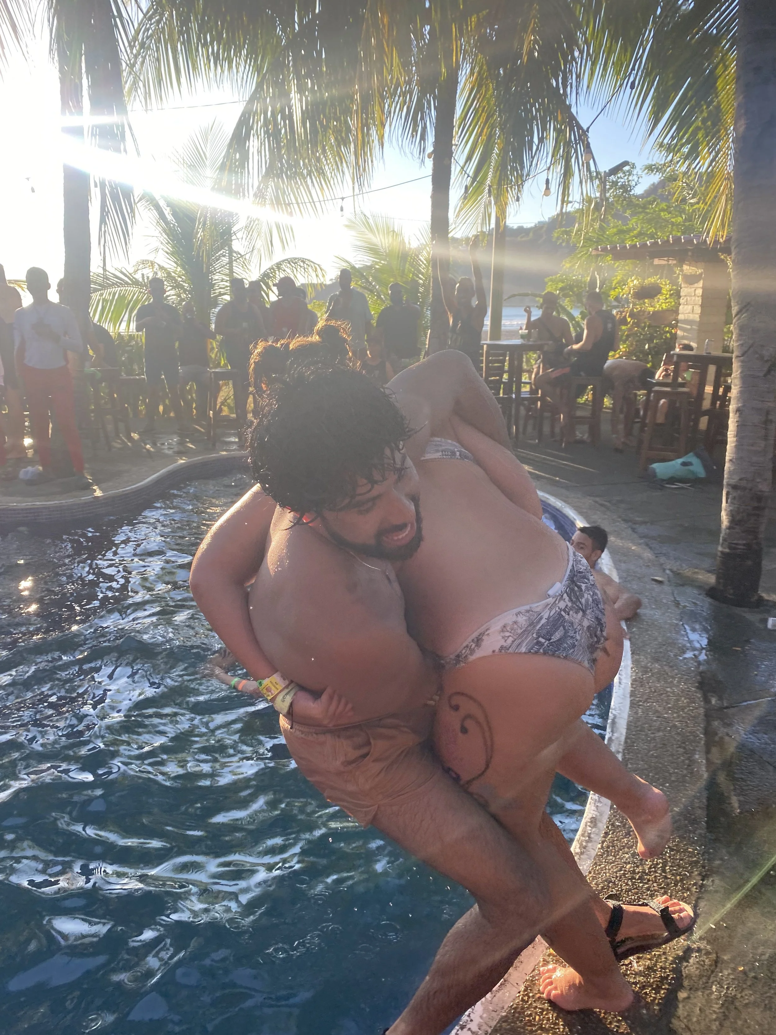 Backpacker being playfully pushed into a swimming pool during Sunday Funday in San Juan del Sur, Nicaragua.