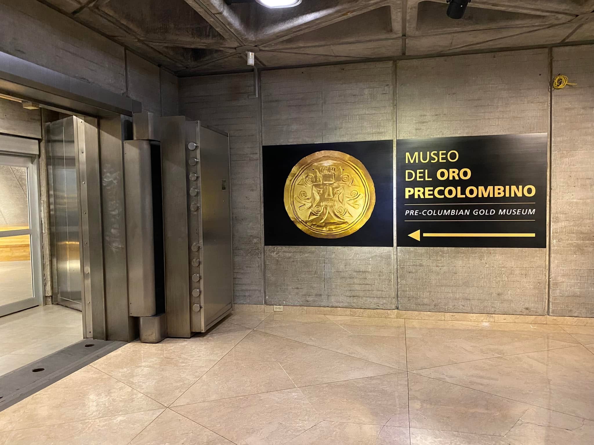 Massive open steel vault doors beside the entrance sign for the Pre-Columbian Gold Museum in San José, Costa Rica.