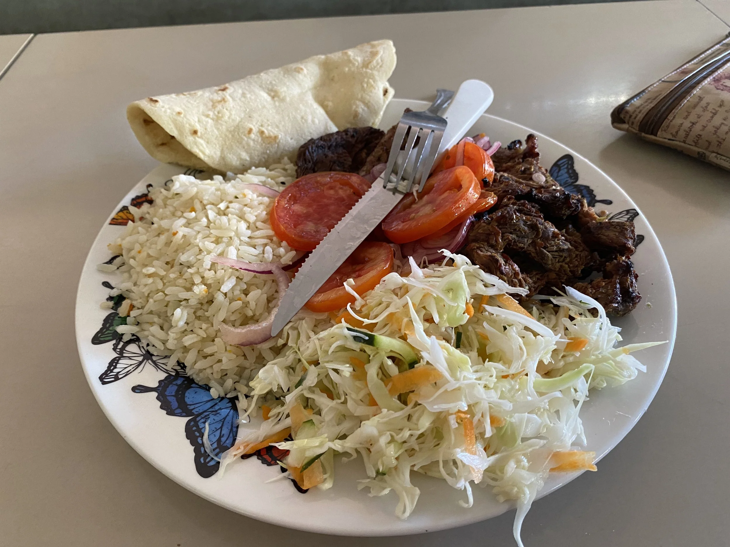 Traditional Nicaraguan meal with rice, meat, salad, and tortilla in León