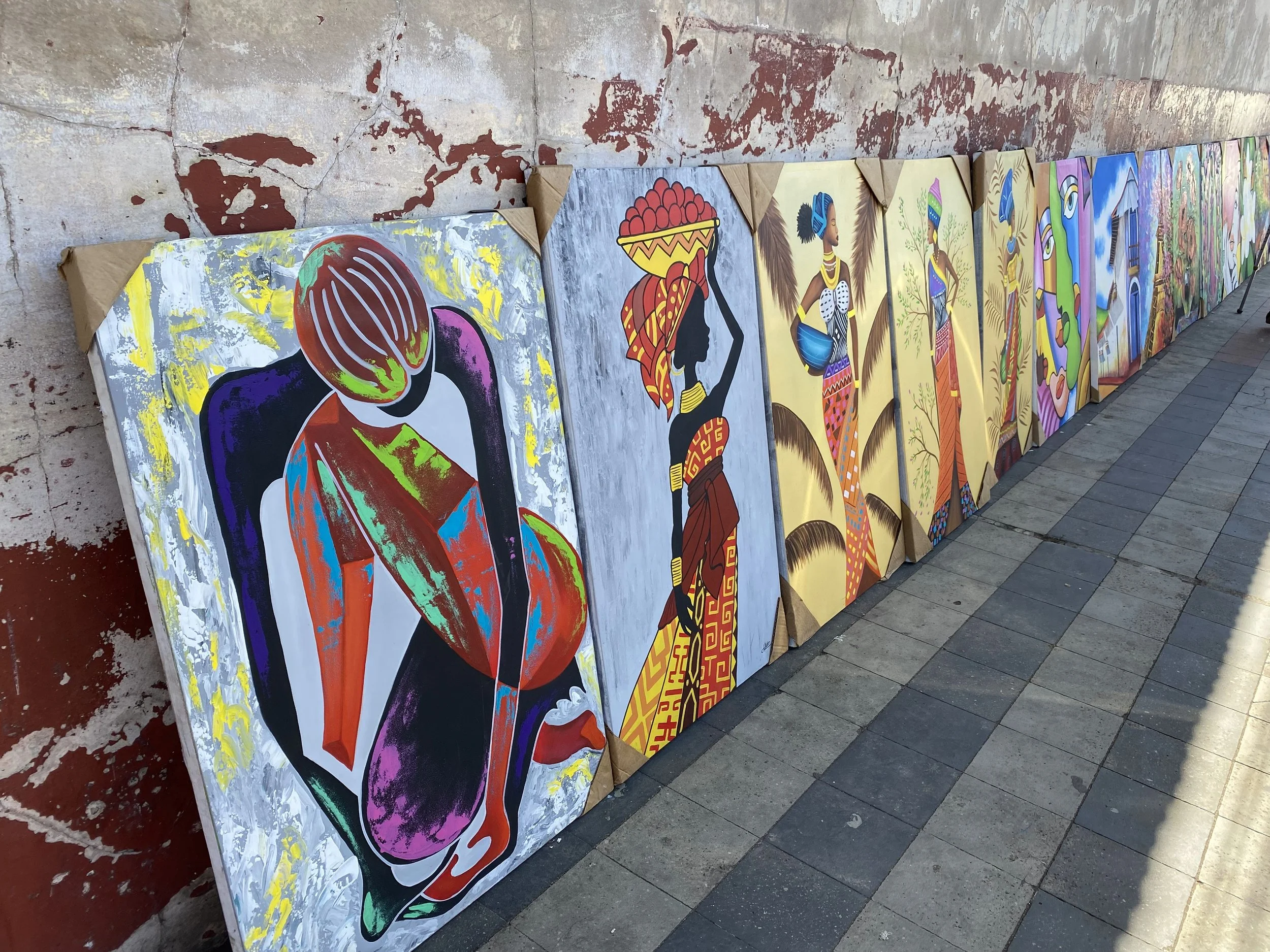 Colorful local artwork and paintings displayed on street in León Nicaragua