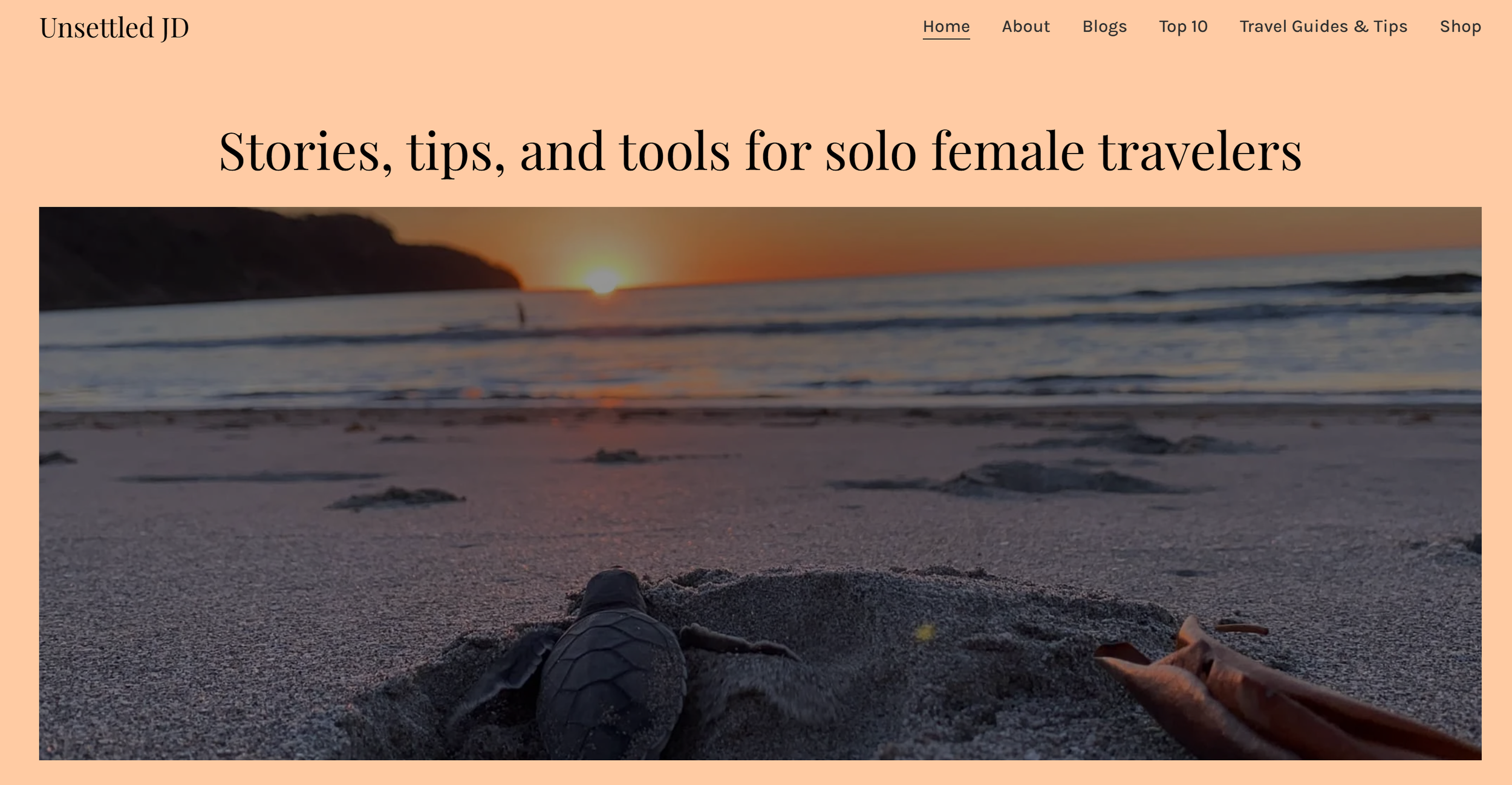 Screenshot of the Unsettled JD homepage featuring a sea turtle hatchling on a beach at sunset beneath the heading "Stories, tips, and tools for solo female travelers."